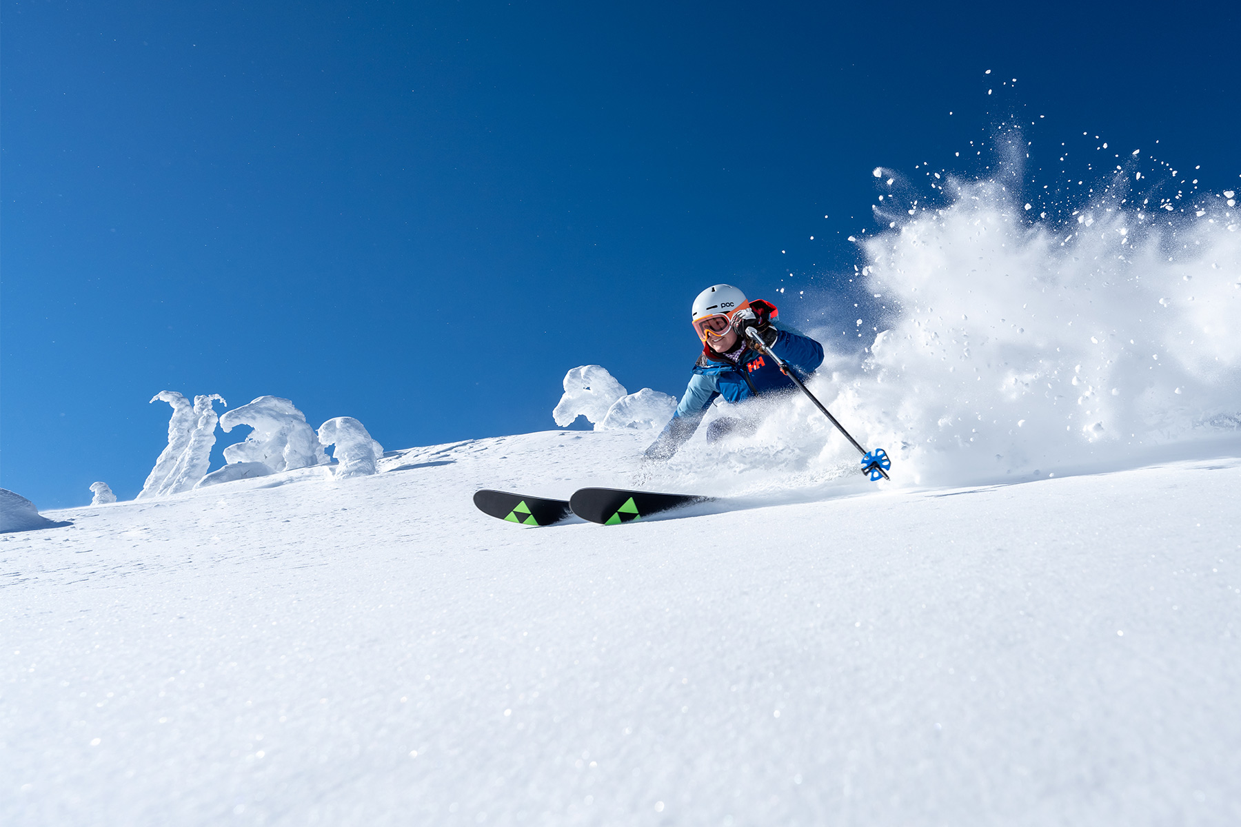 Skier in powder with blue sky