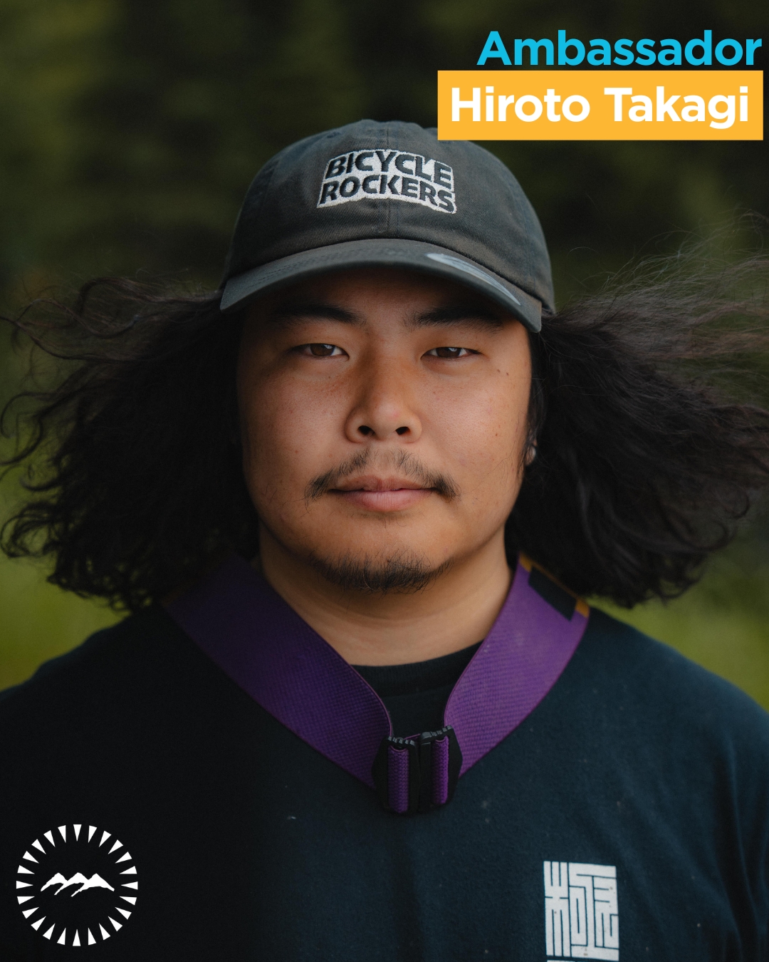 man looking into camera with hair blowing in the wind