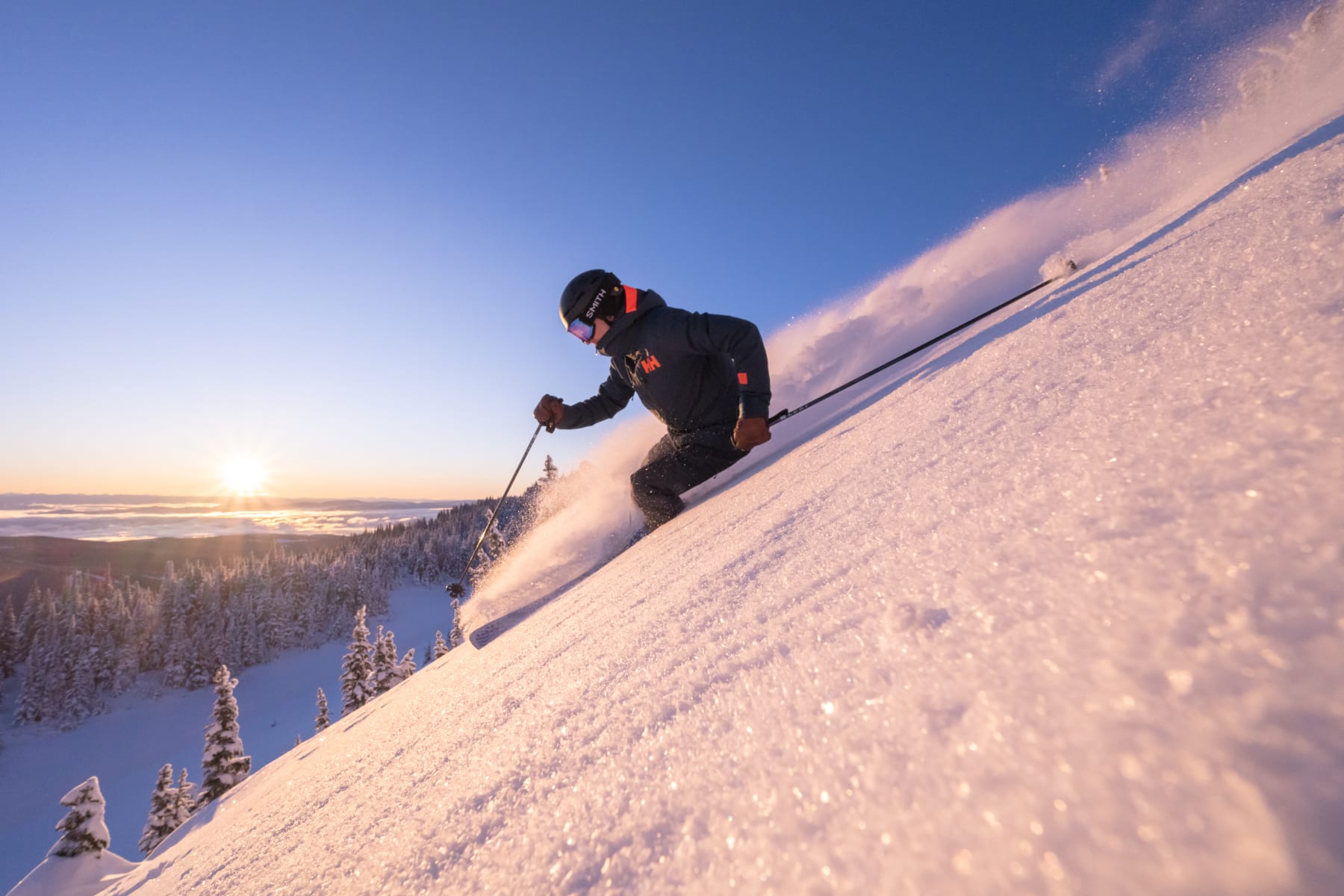 Skier with an open blue sky and sparkling powdery snow
