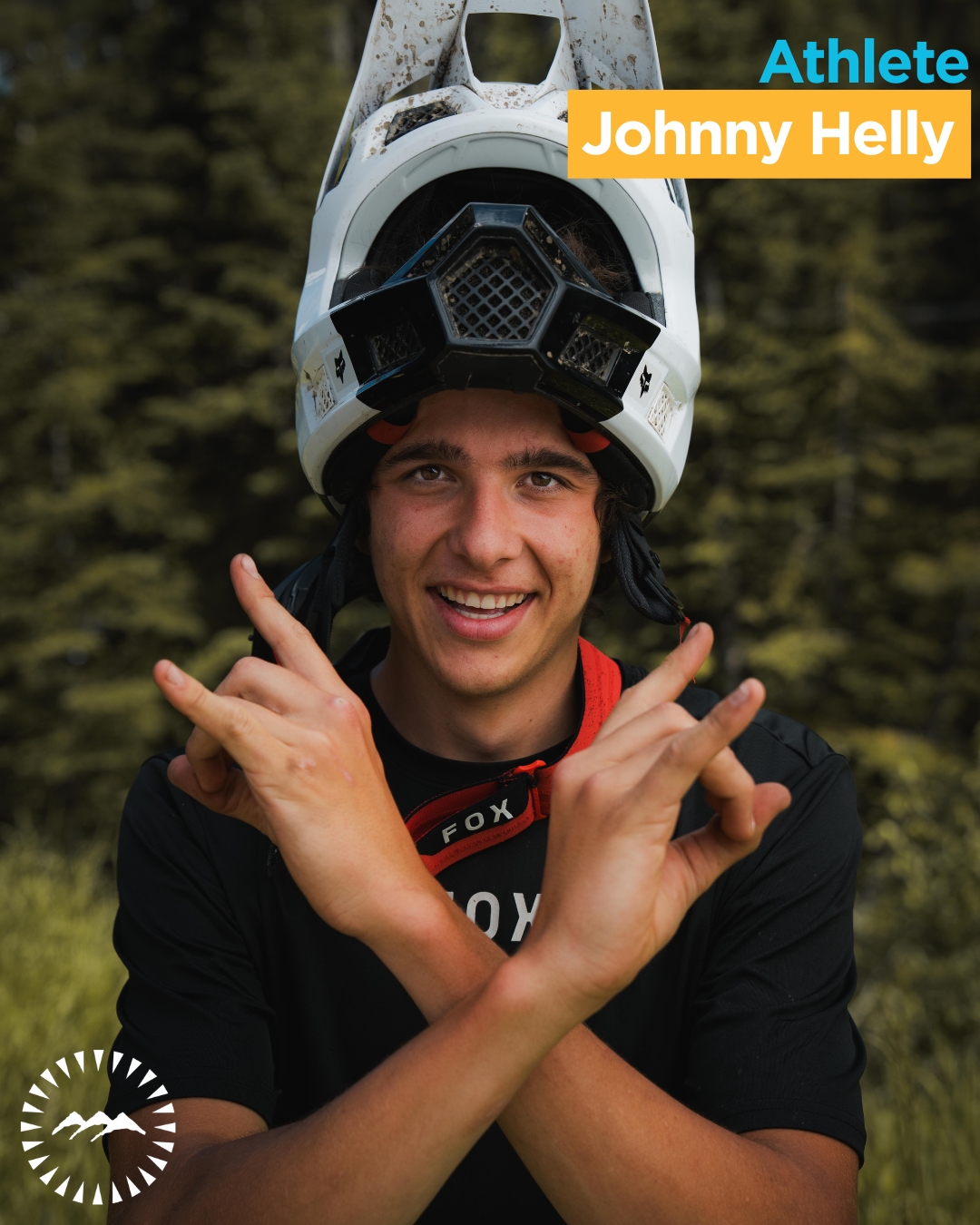 boy looking into the camera smiling with trees behind him