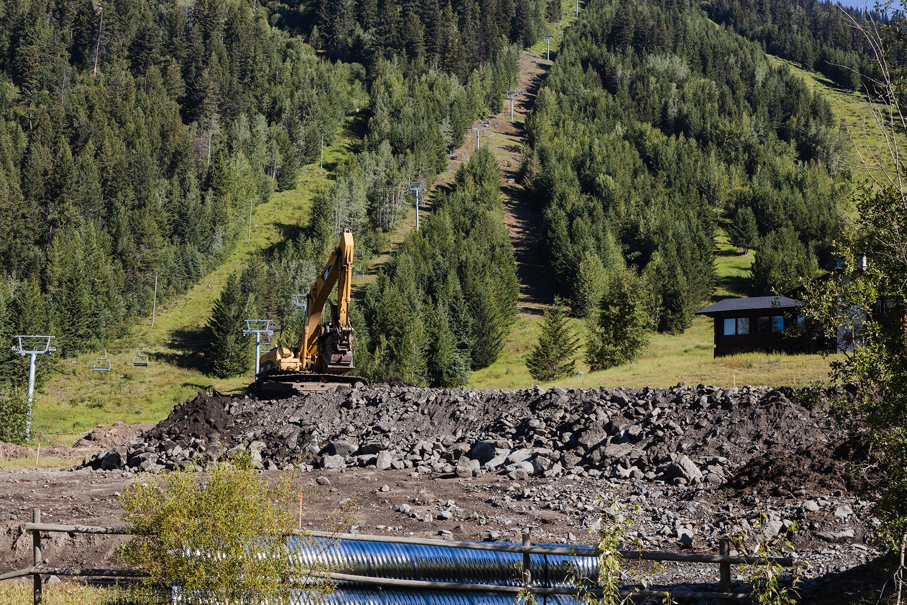 Photo of excavator building new P1 parking lot with Burfield chairlift in background.