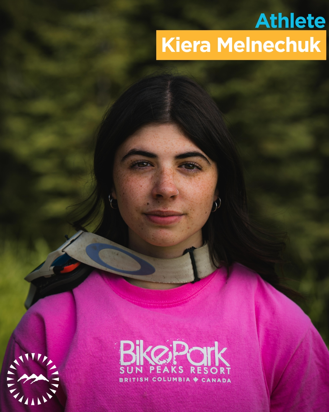 girl looking into the camera wearing a pink shirt 