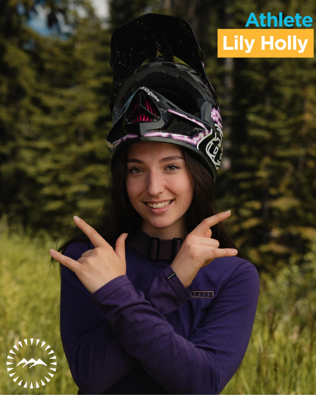 girl smiling into the camera with trees behind her