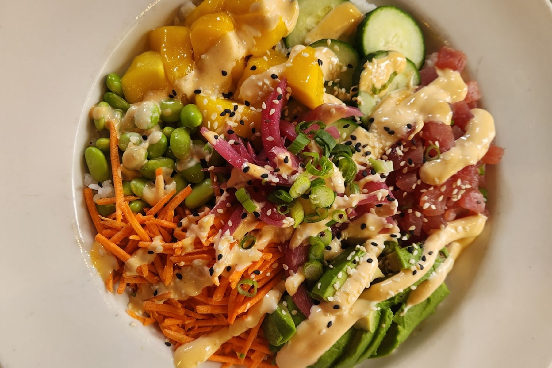 Poke bowl with tune, avocado, mango, carrot, and edamame