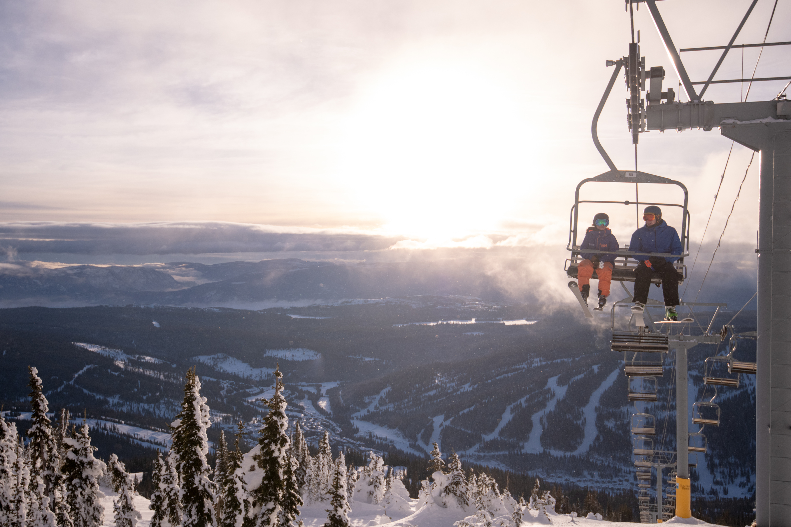 skiers on chairlift at sun peaks