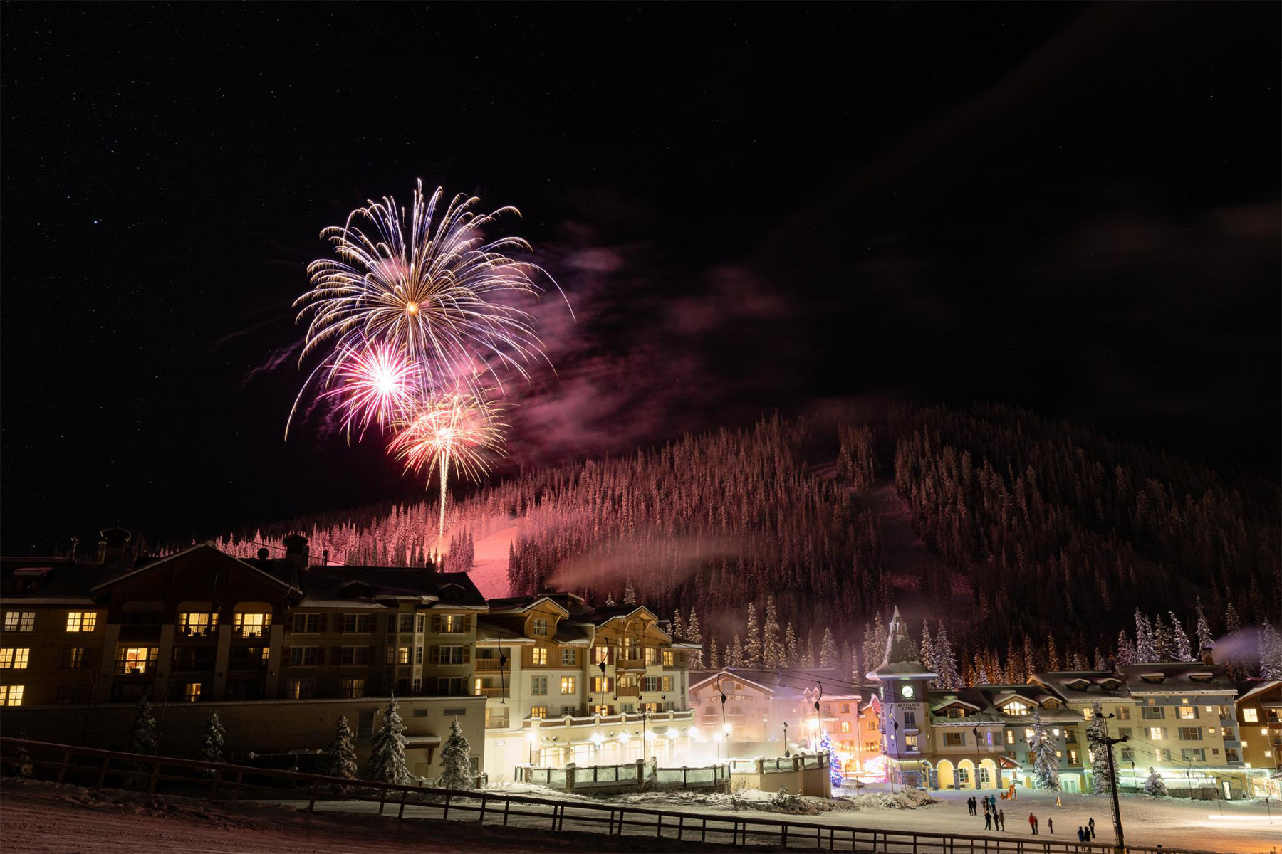 Fireworks in the sky above village buildings