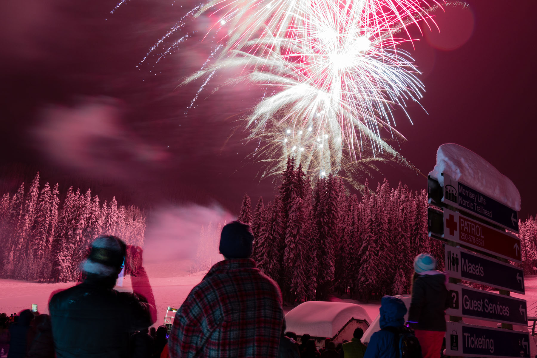 Family watching New Year's Eve fireworks in Sun Peaks