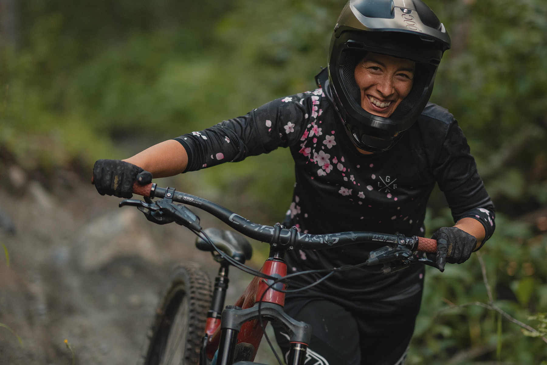 Kelly Kozevnikov walking with bike