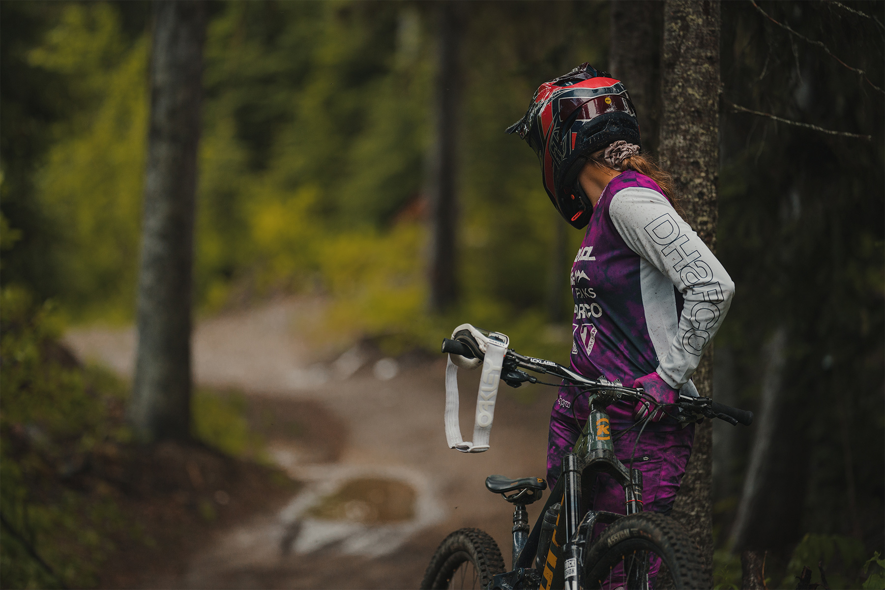 Kyleigh turned away from camera looking at mountain bike trail