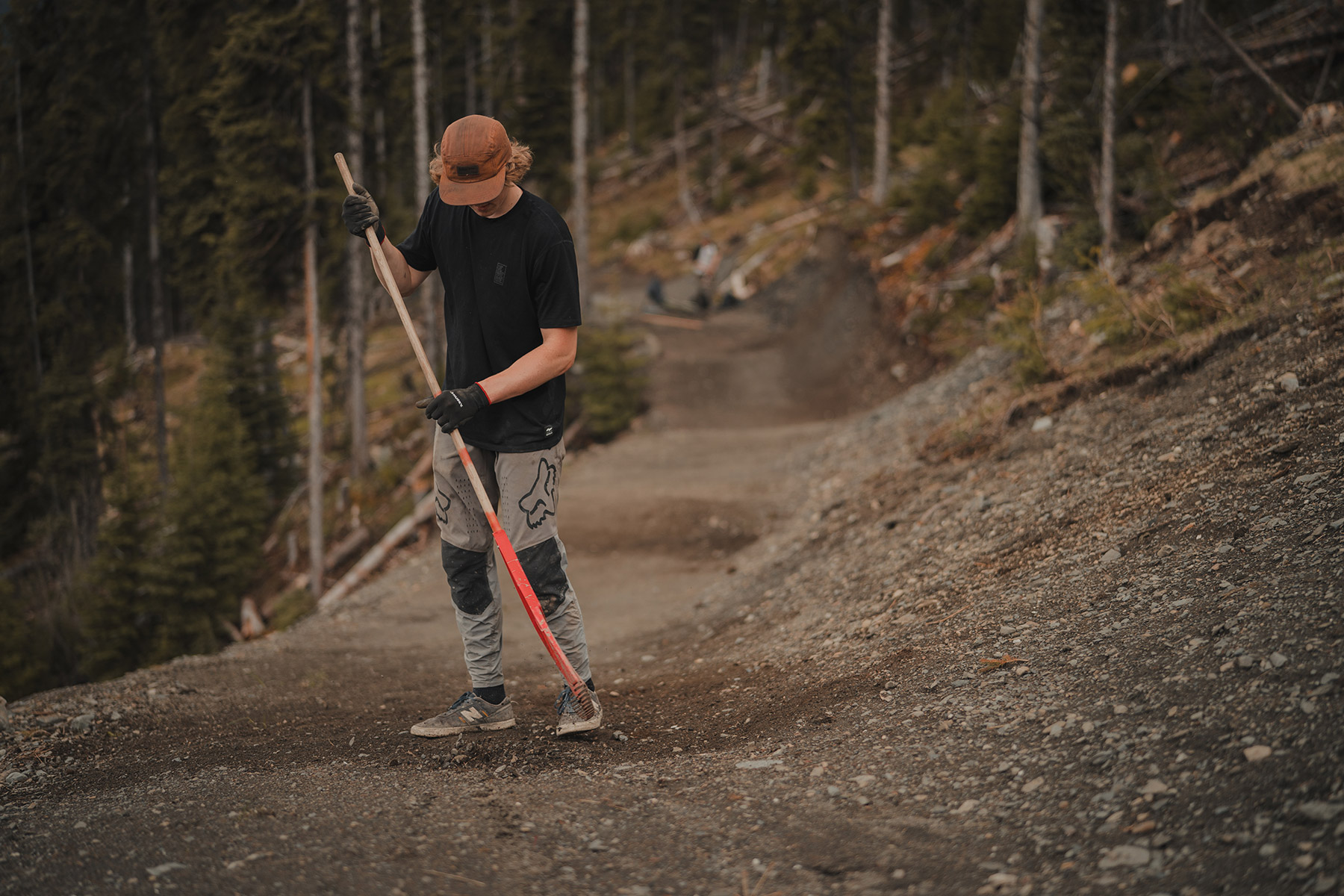 Trail builder raking trail