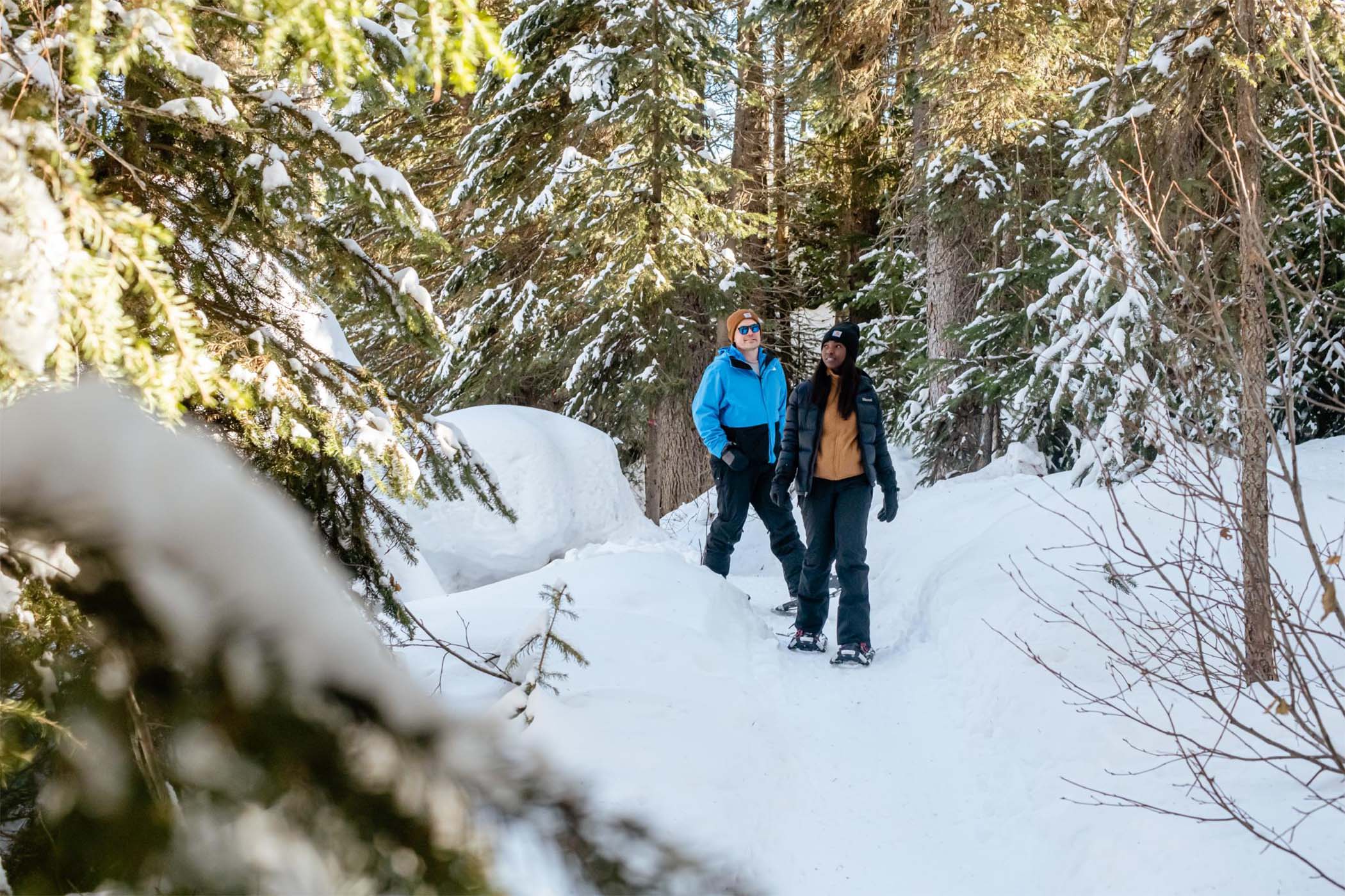 Matt and Chioma snowshoe through an enchanting winter forest.