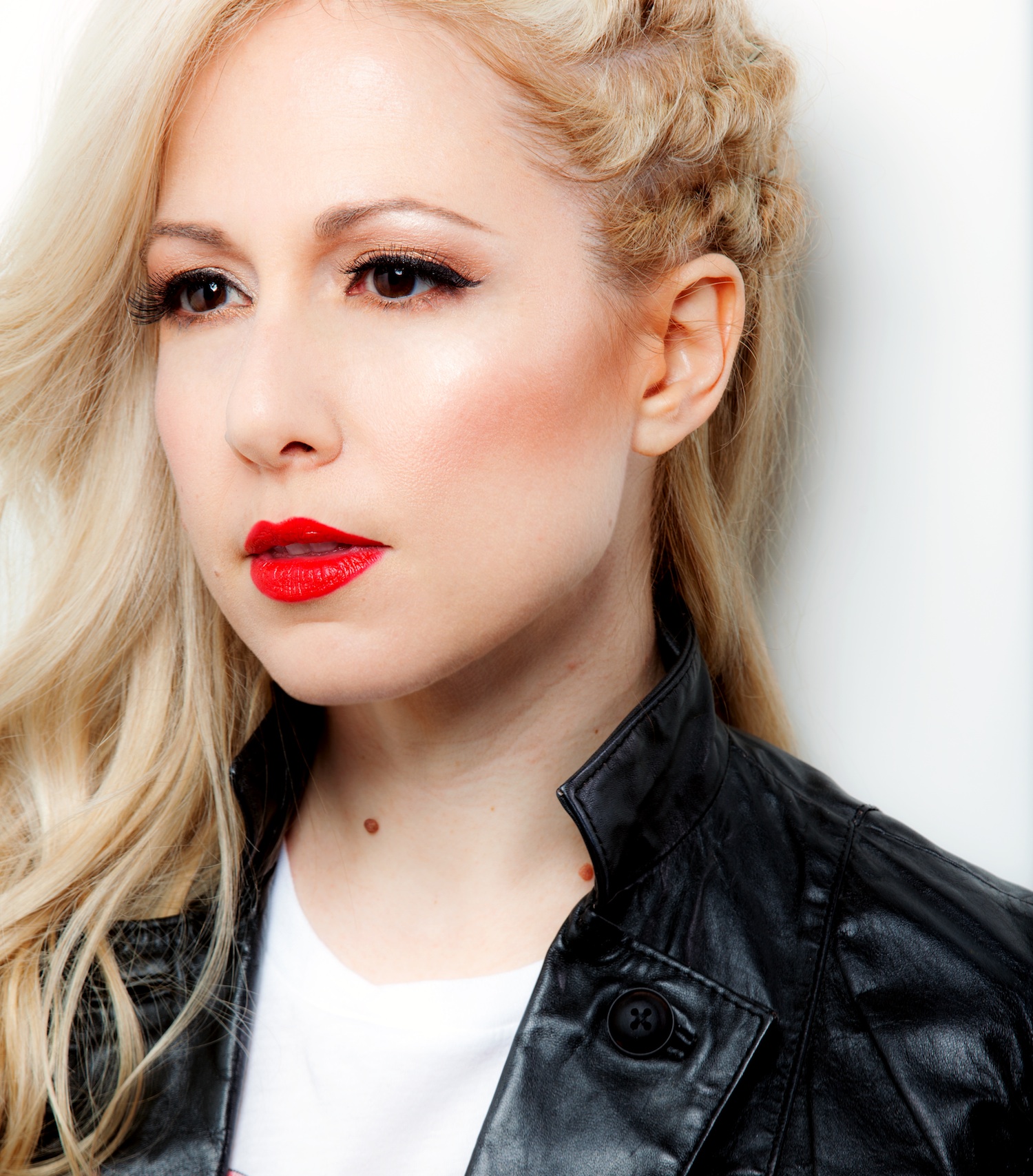 Colette - DJ with long blond hair and red lipstick.