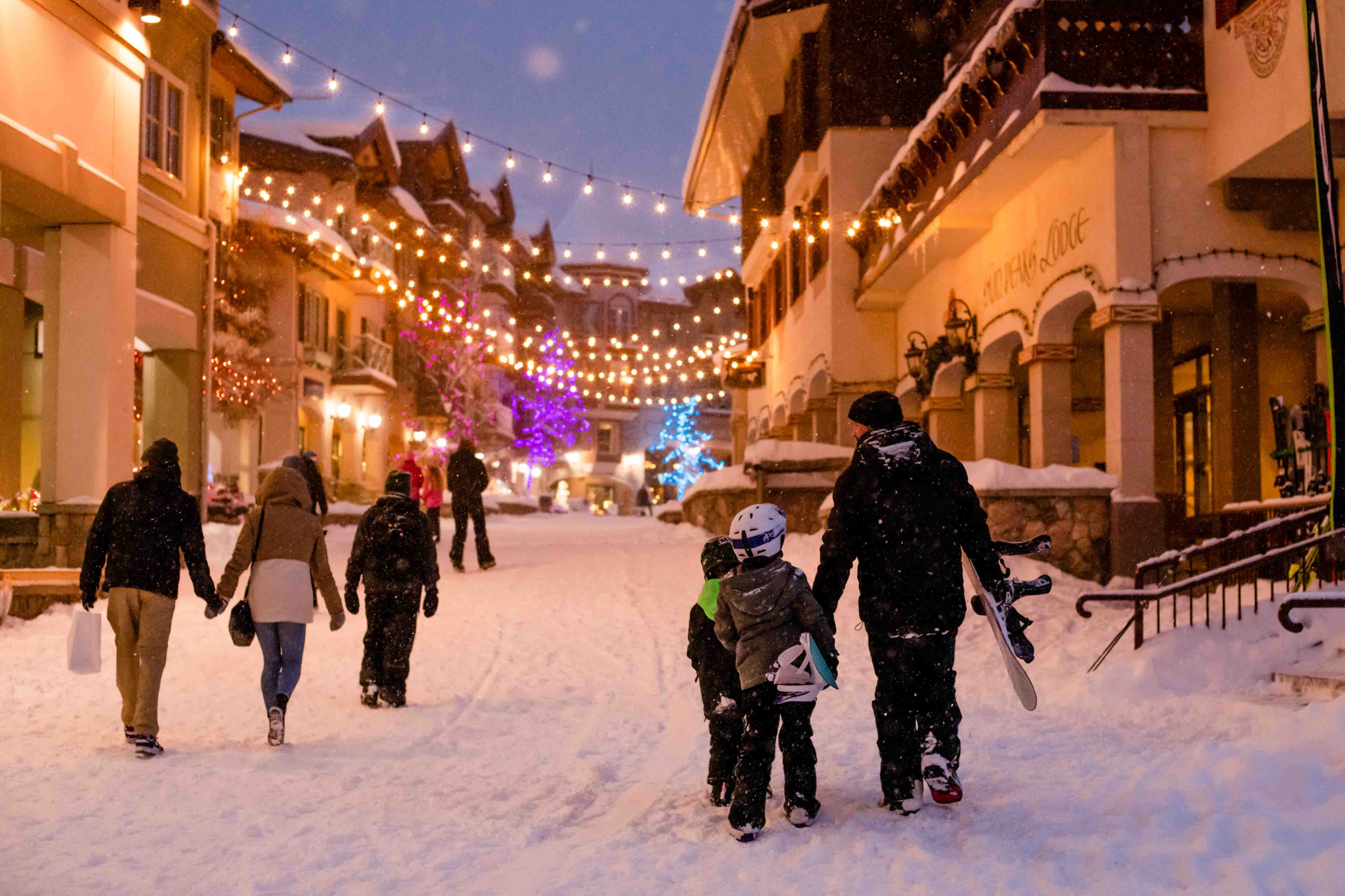 family walking in sun peaks village