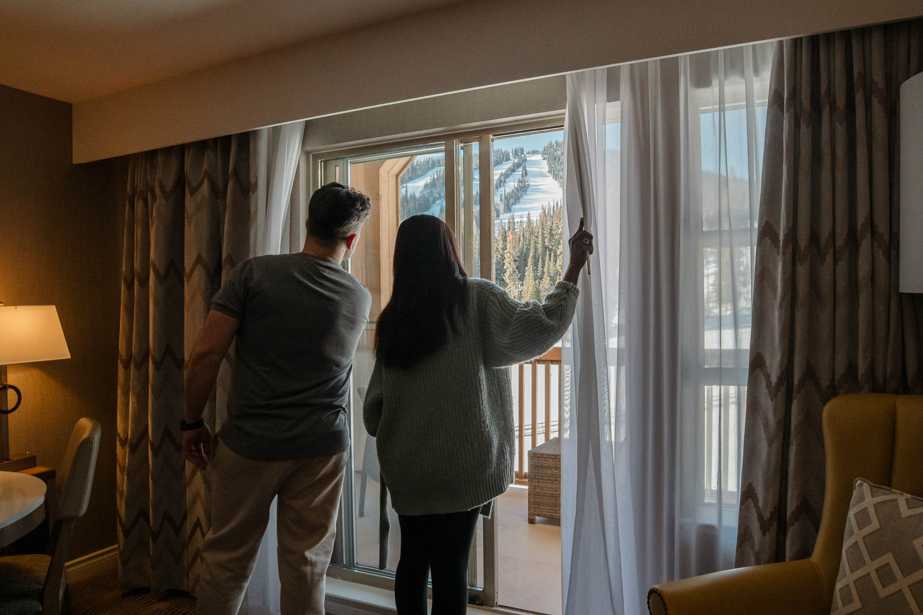 couple enjoying the view in their room at sun peaks