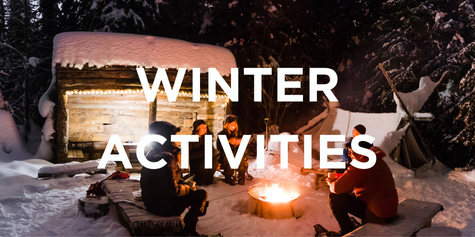 People sitting around a campfire in with snowshoes on