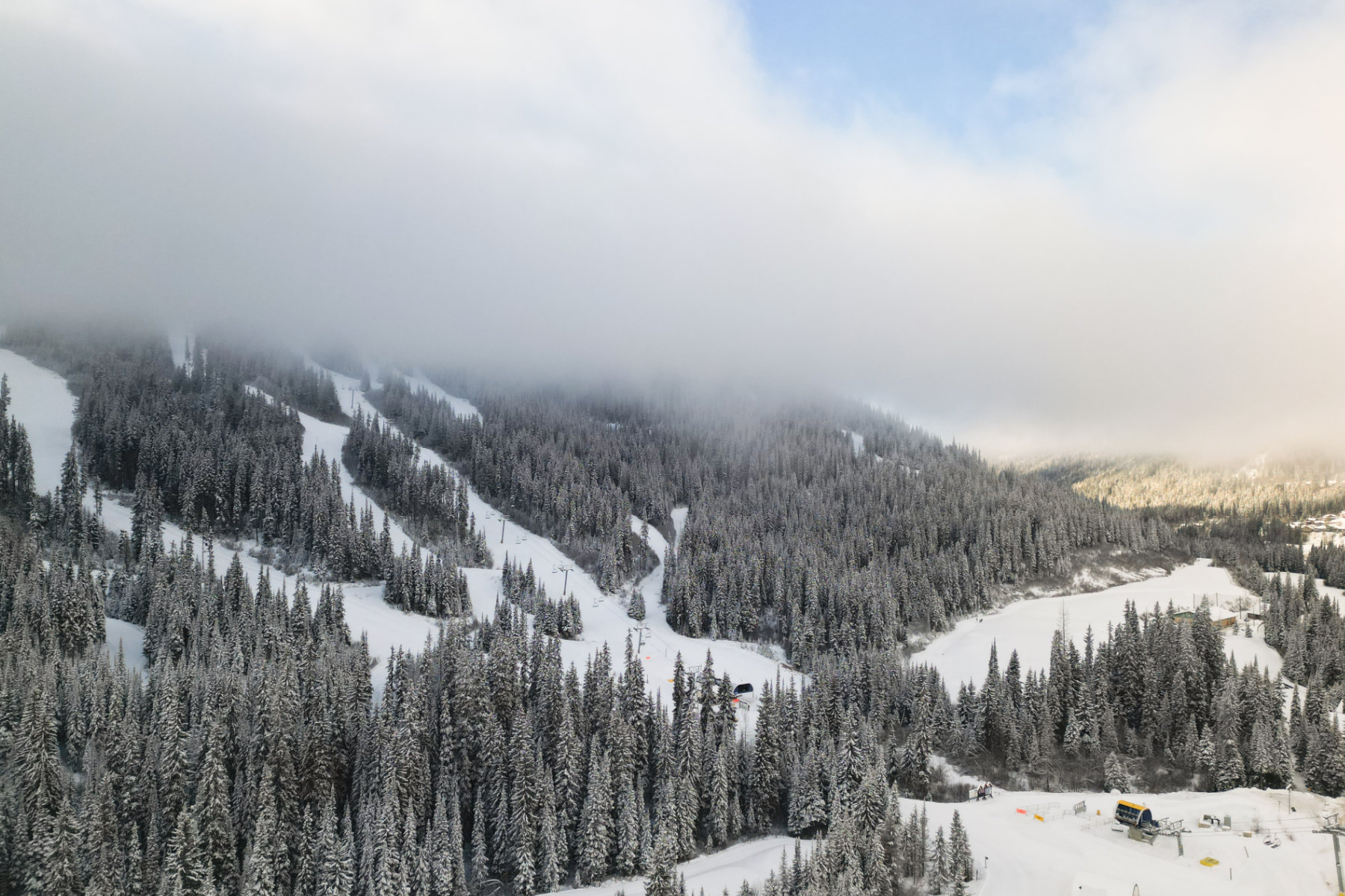 View of the ski runs in the winter with clouds over them