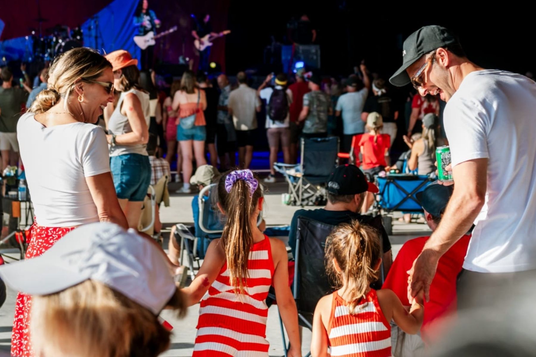 Family of four enjoying a concert at the Sun Peaks Centre Stage