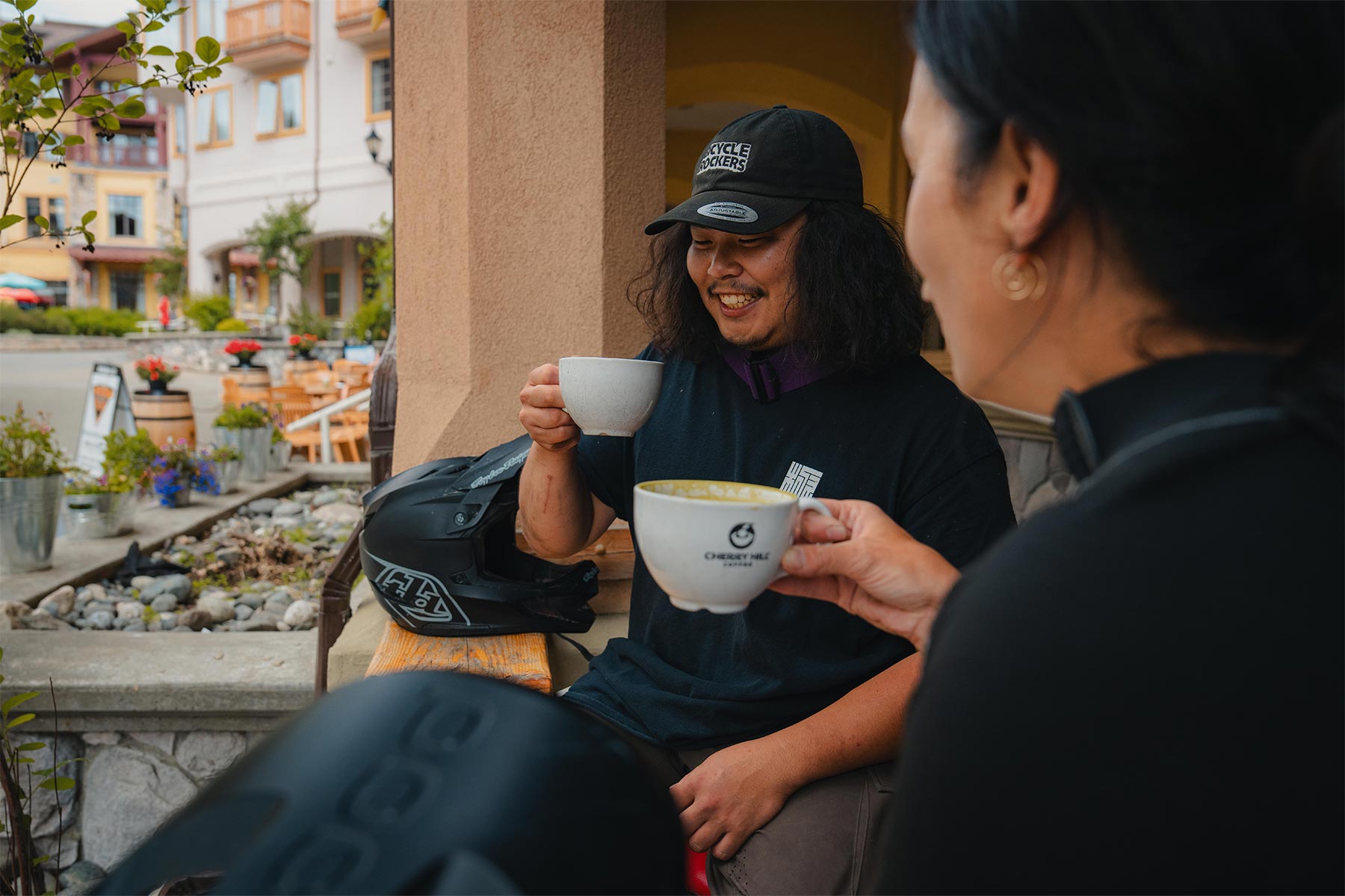 two people drinking coffee in a village