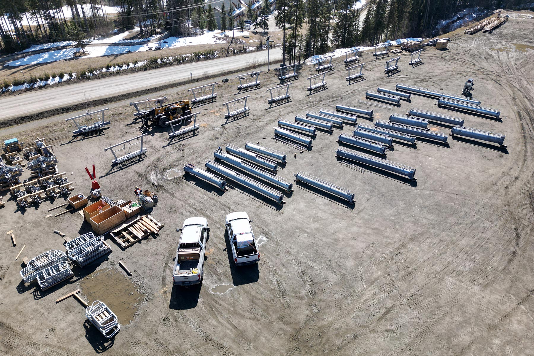 Aerial view of lift towers for new West Bowl Express chairlift staged in parking lot.