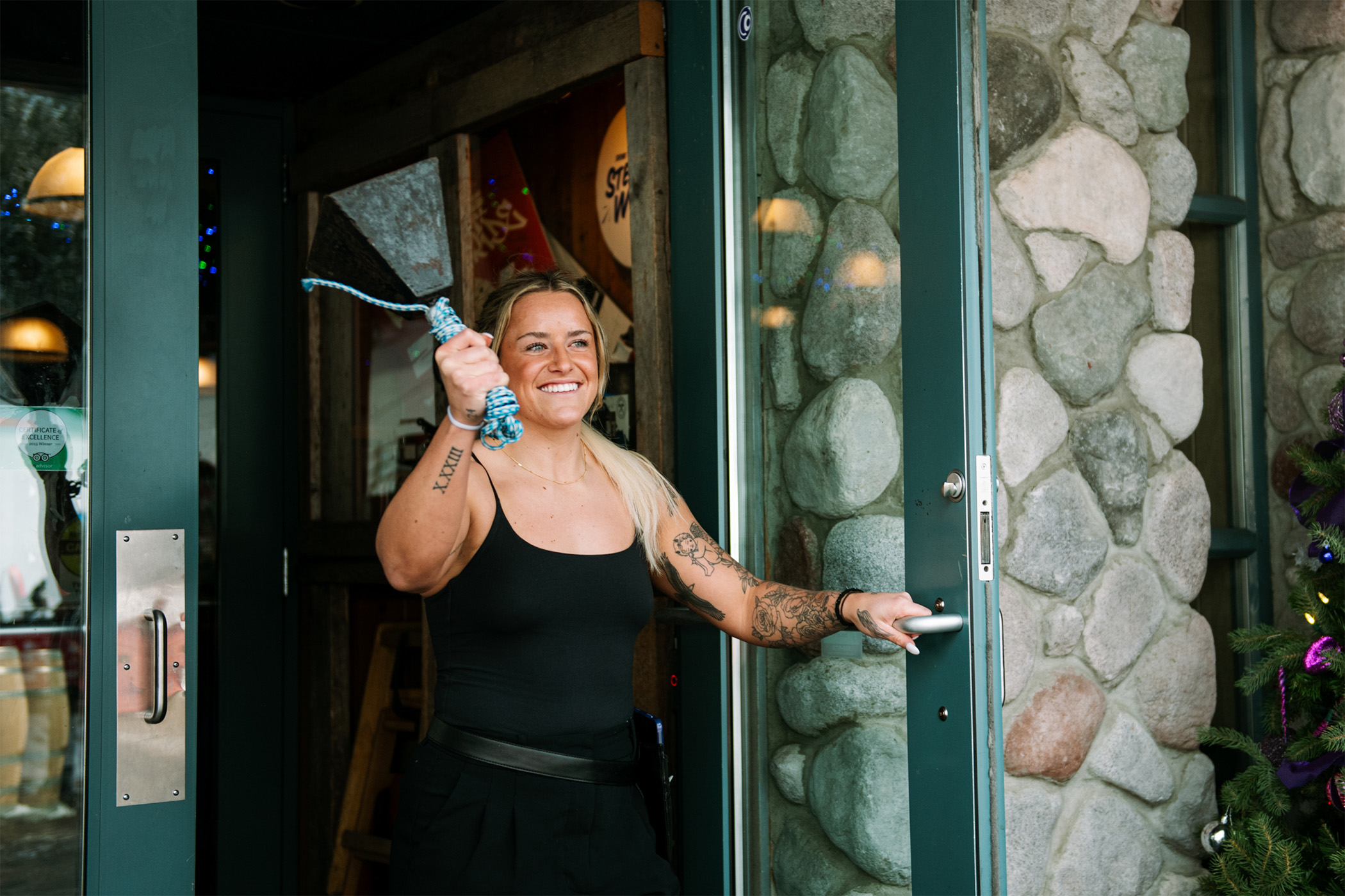 Ainsley smiles and rings the Après bell out of the doorway Bottoms.