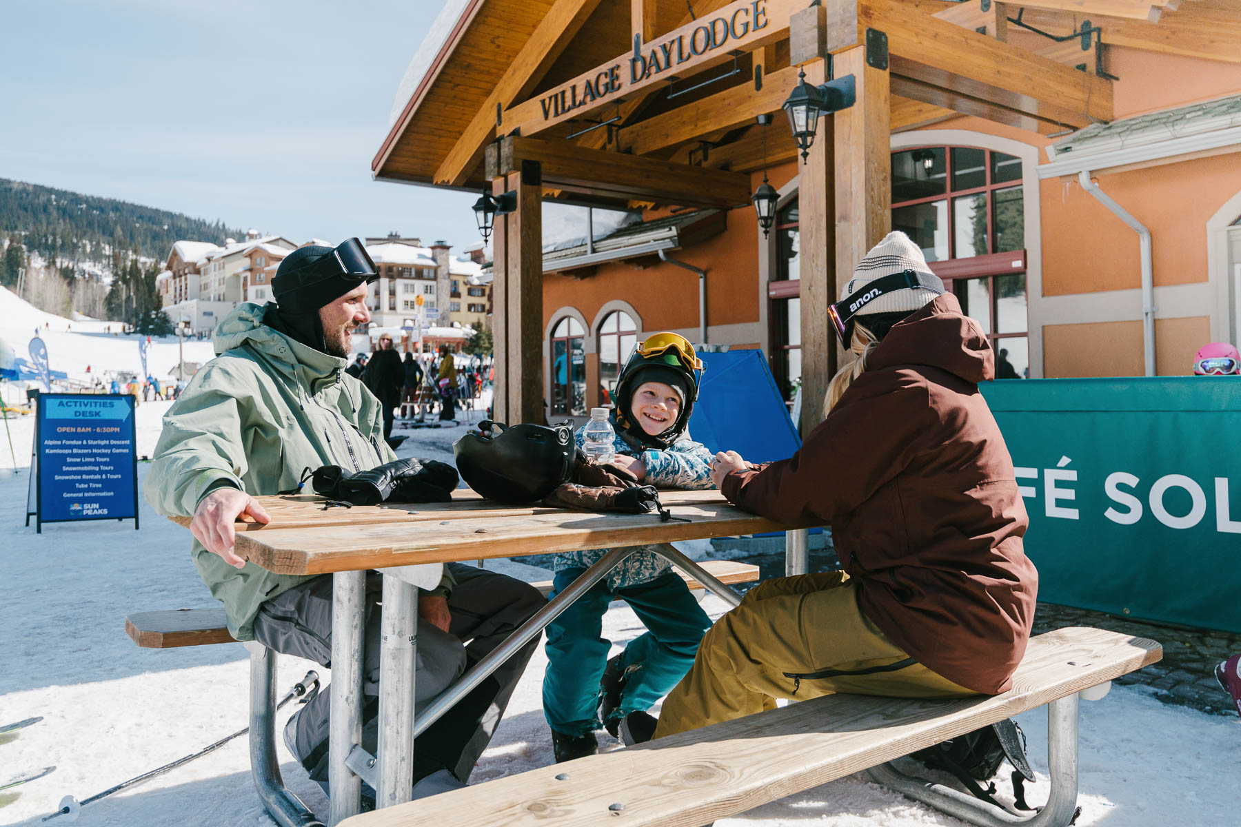 family snowboarding in sun peaks