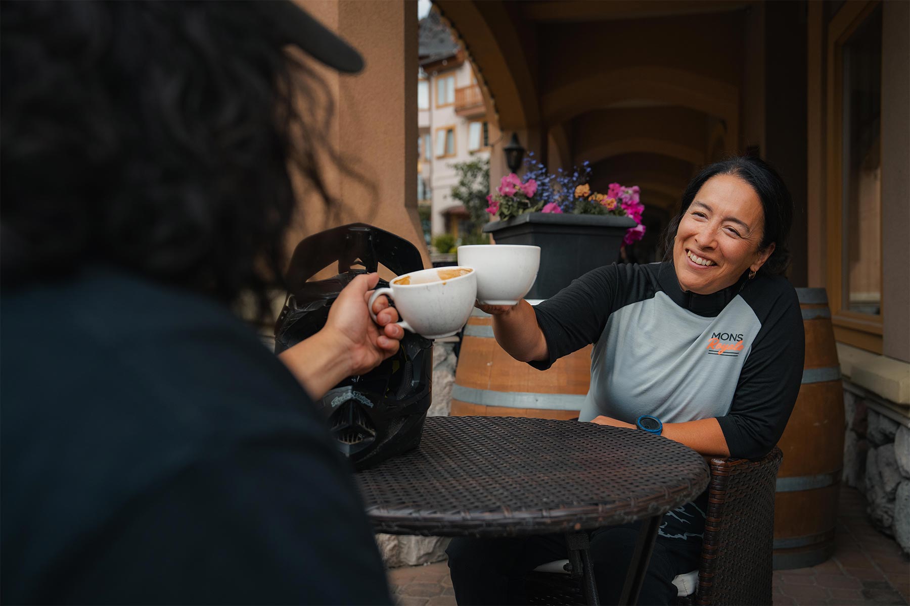 two people cheersing their cups together 