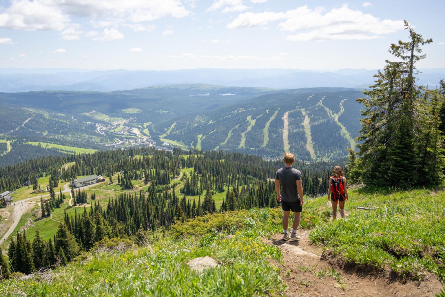 Couple summer hiking in the alpine in Sun Peakls