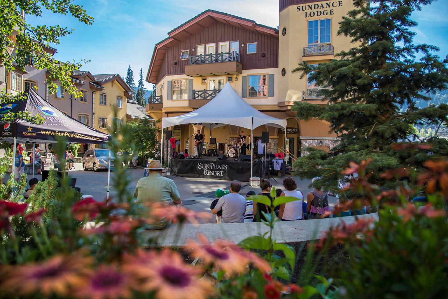 Tents and tables set up for a market below a clocktower
