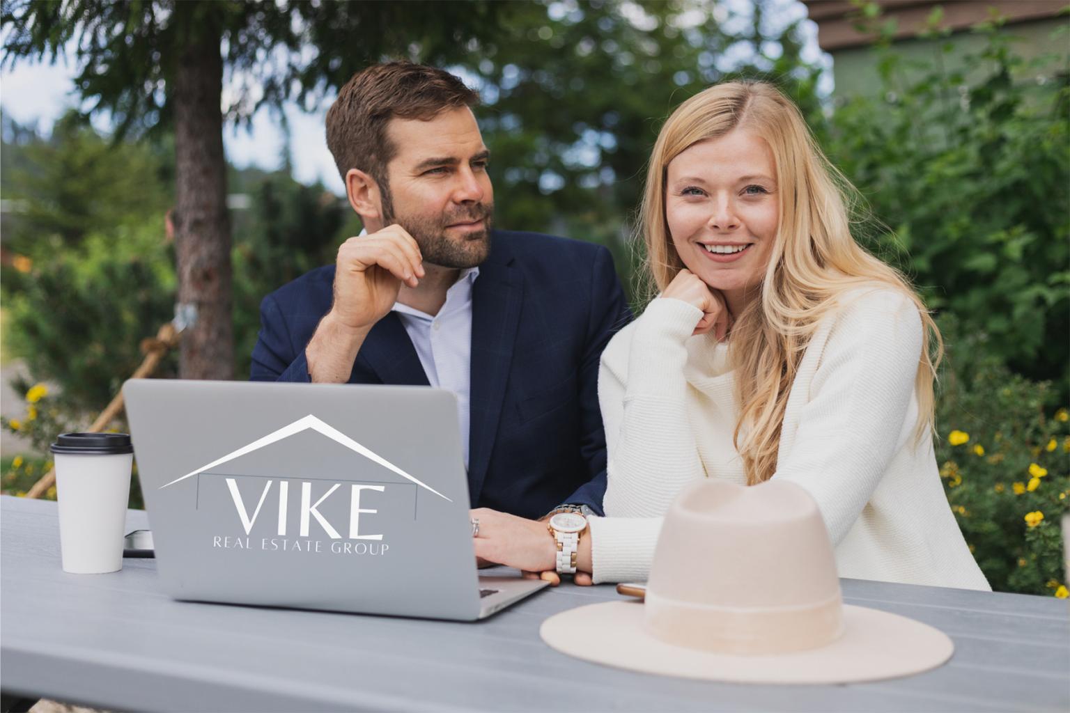 Realtors at table on laptop outdoors
