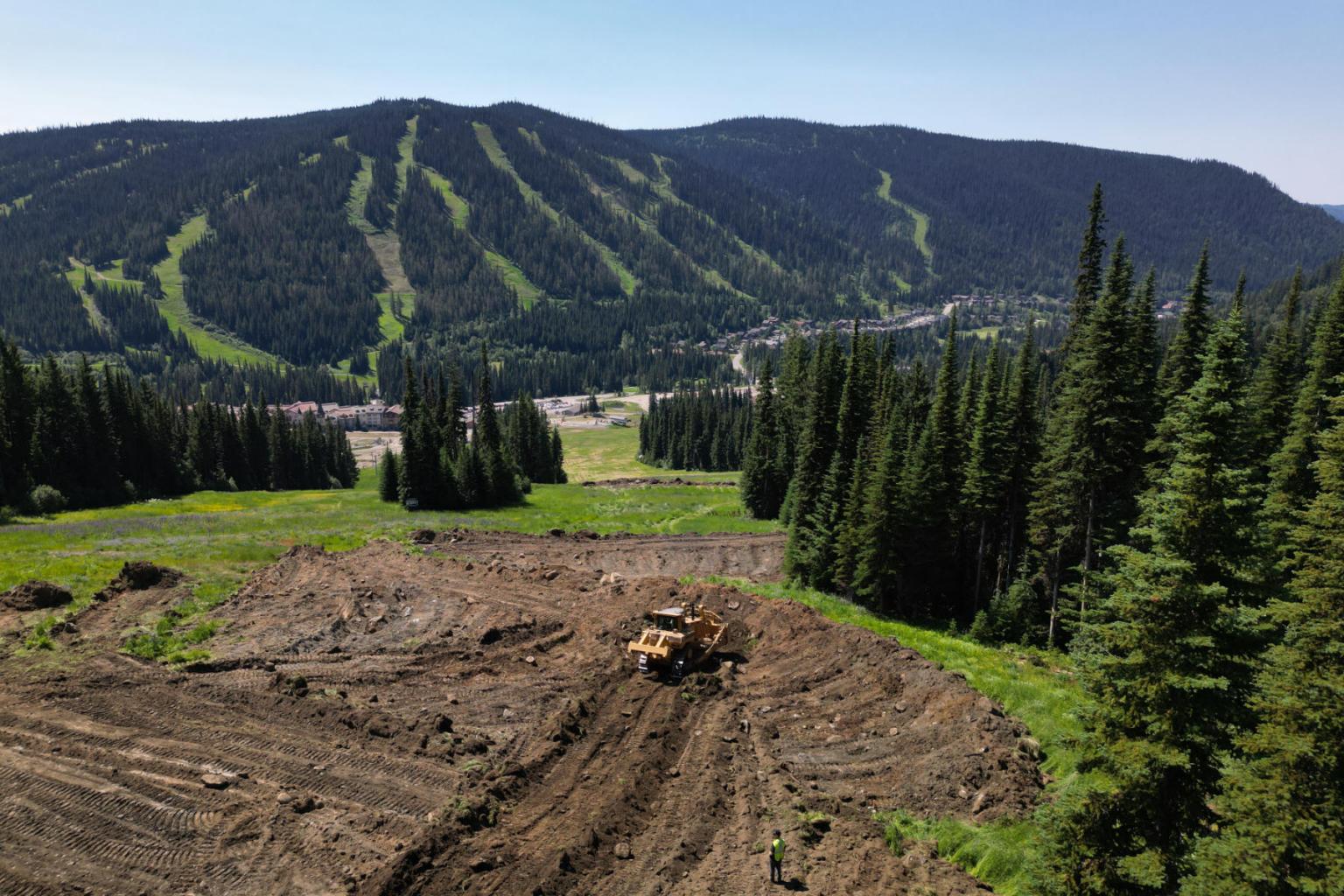 View of the mountain with a tractor in the dirt