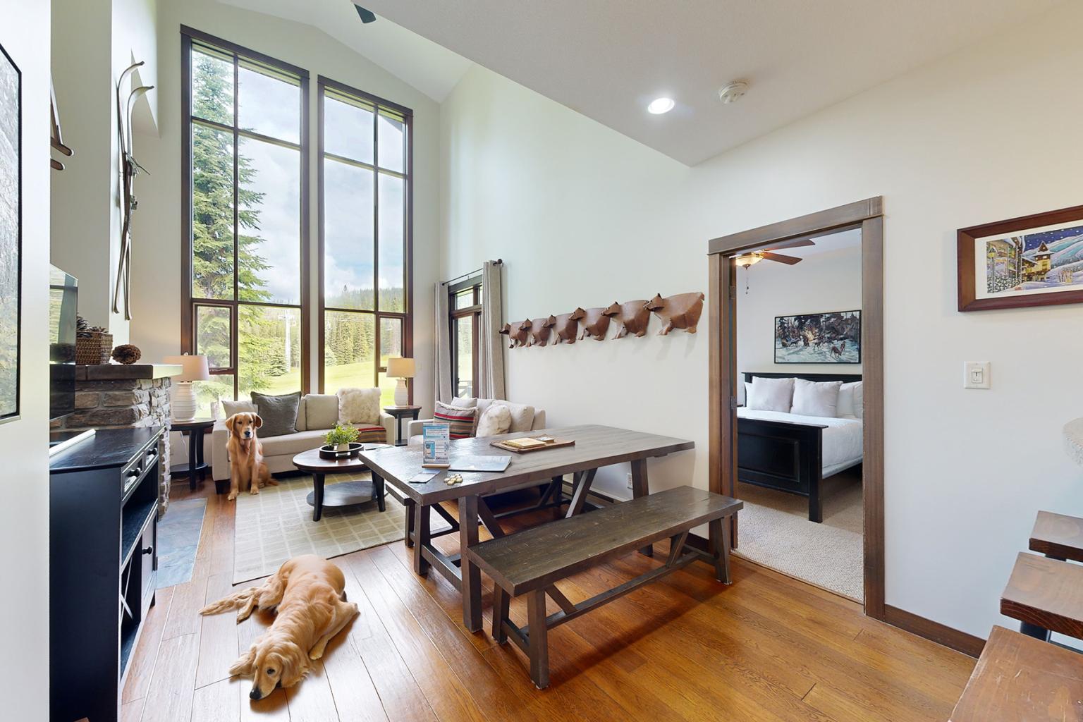 Two happy dogs lounging in a condo in Sun Peaks