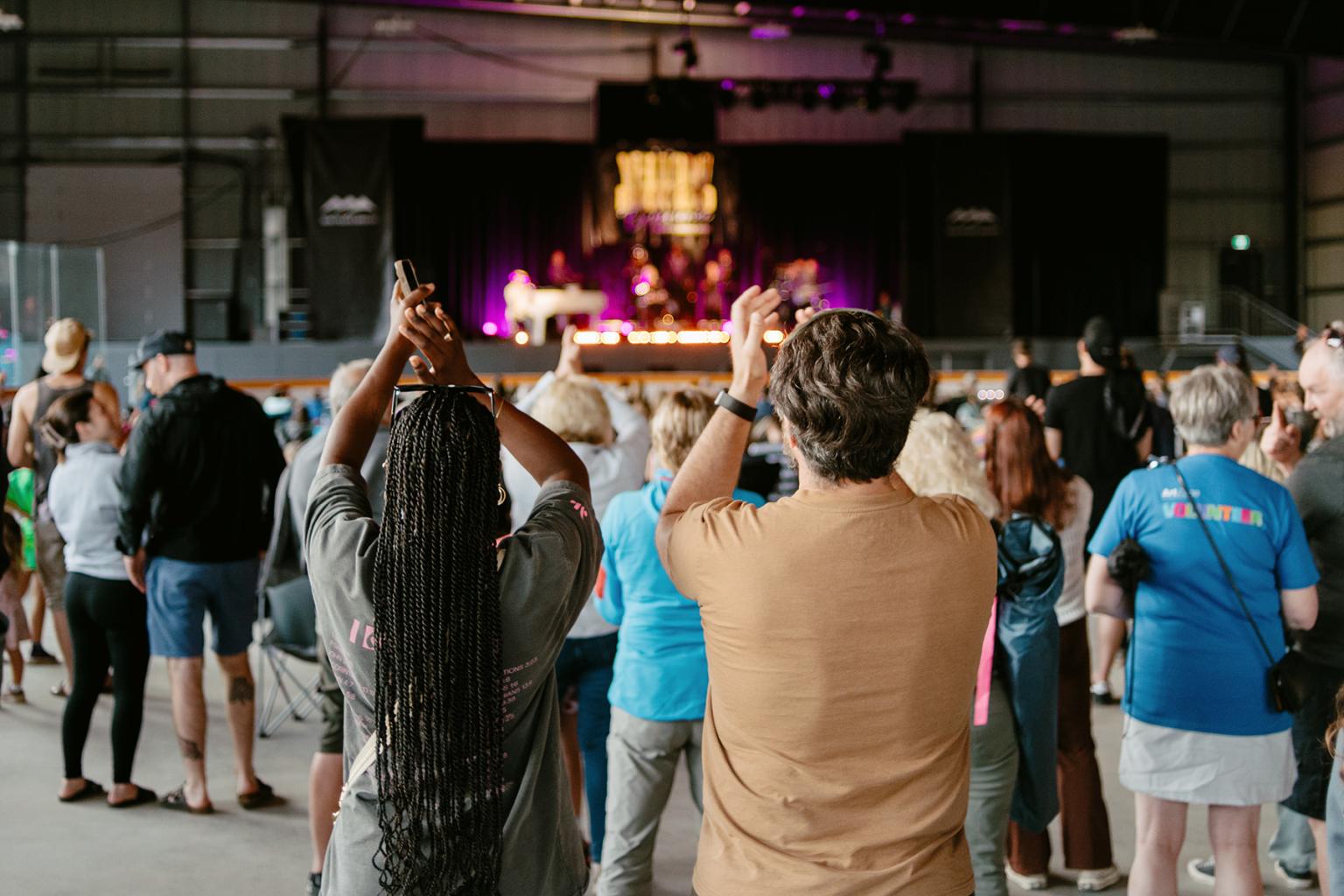 Couple clapping along with concert in Sun Peaks Centre stage