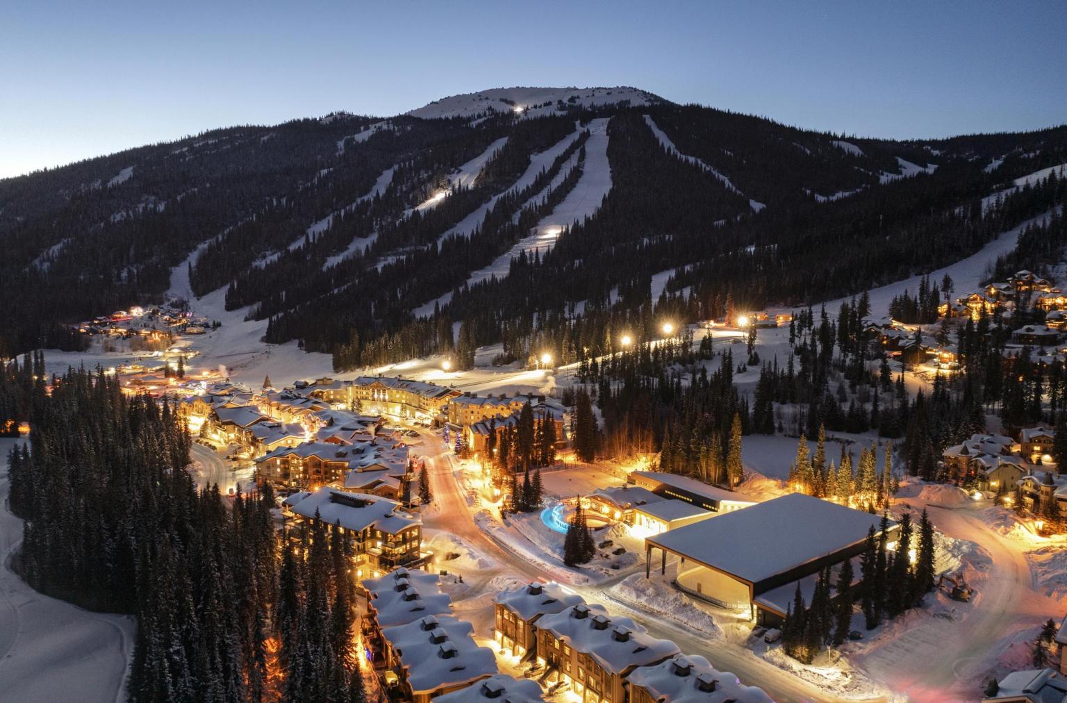 Night time aerial of the sun peaks village with mountain background