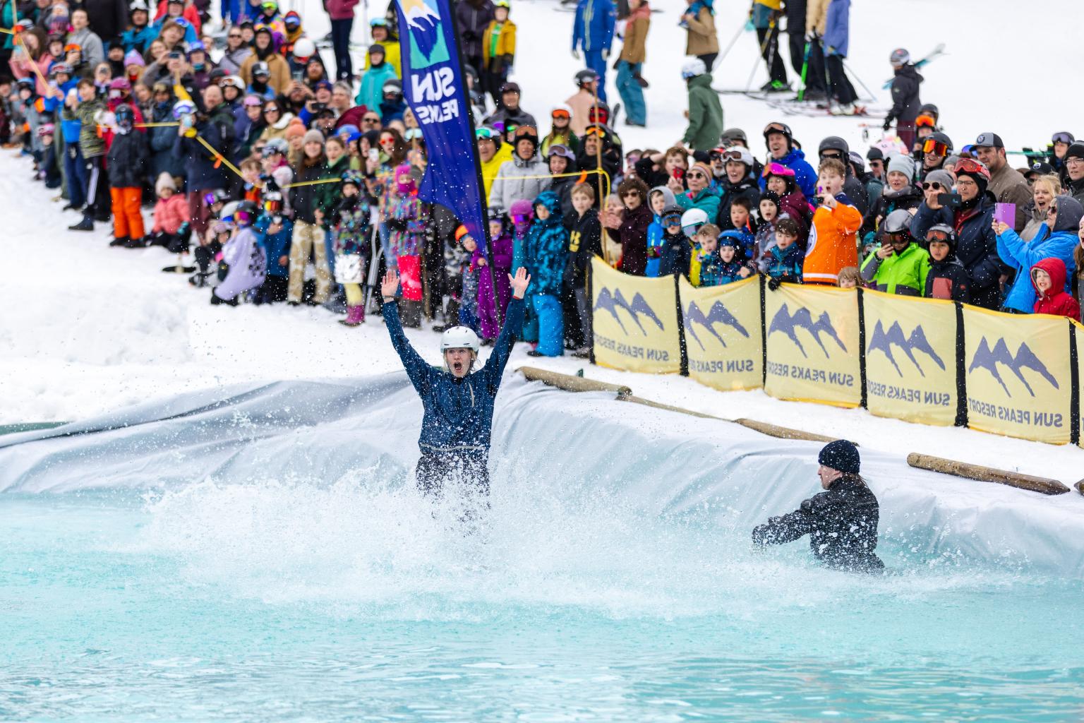 slush cup skiier on water crowd in background 
