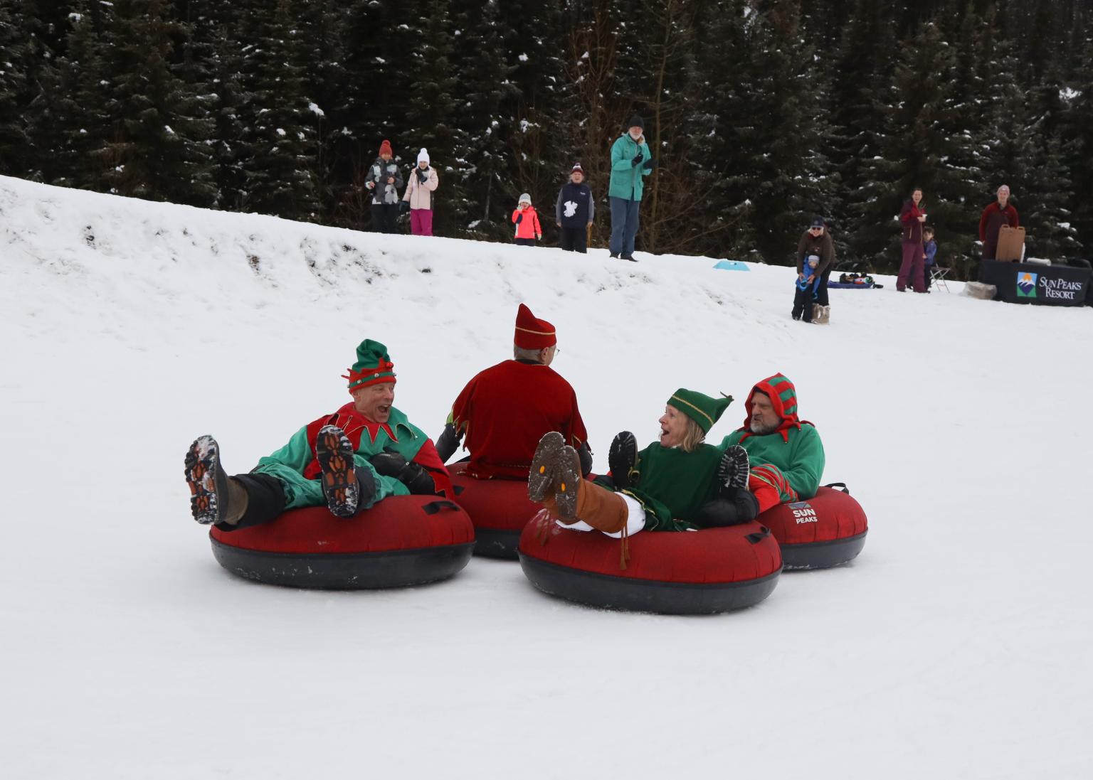 Christmas elves sledding in tubes