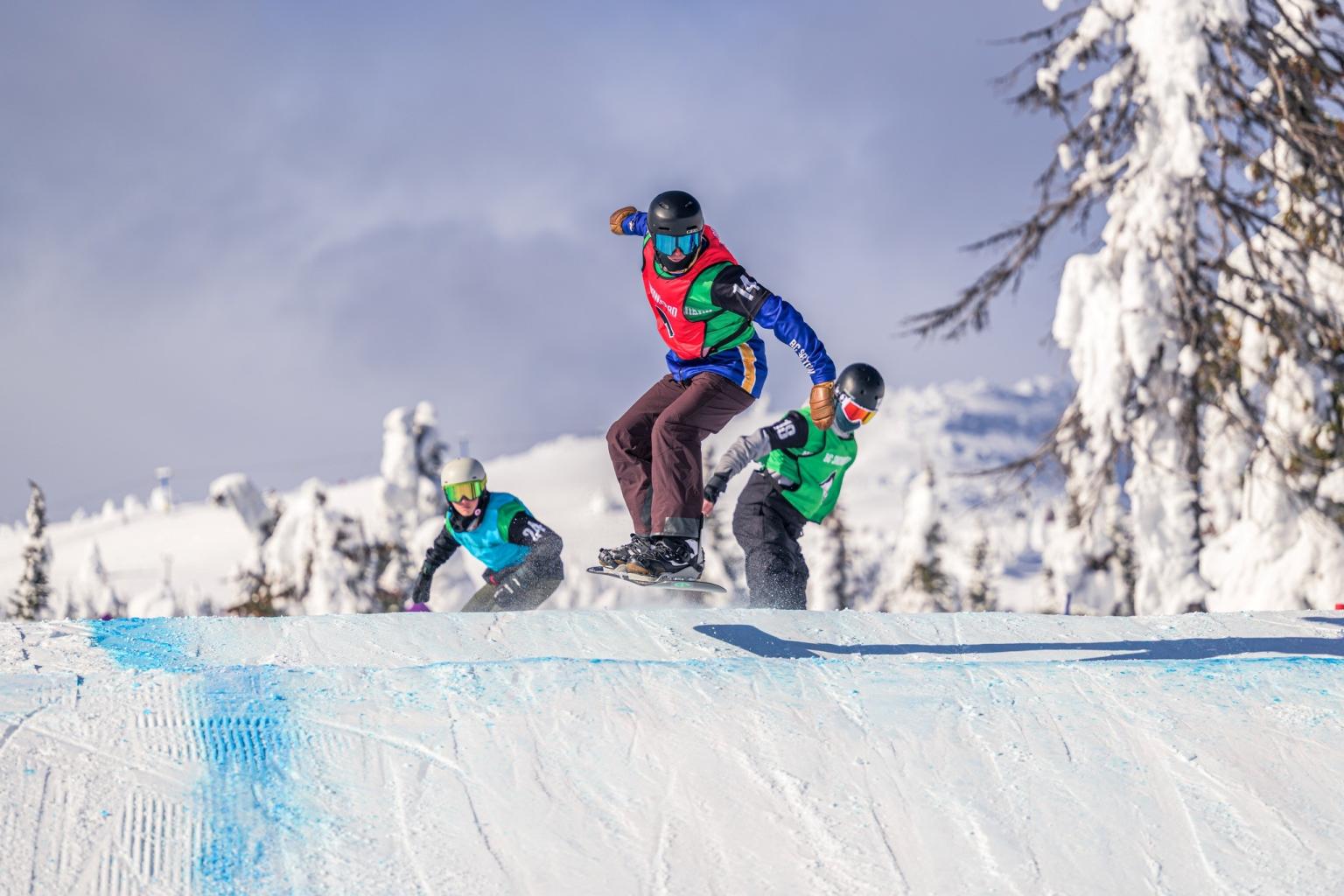 3 racers coming over a roller on the cross track