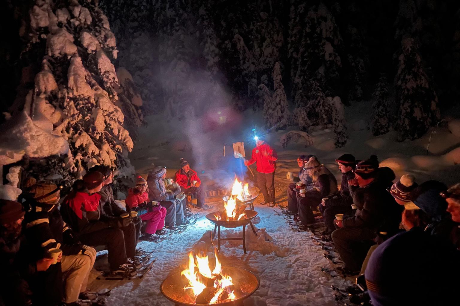 Snowshoe Night Camp visitors around firepits