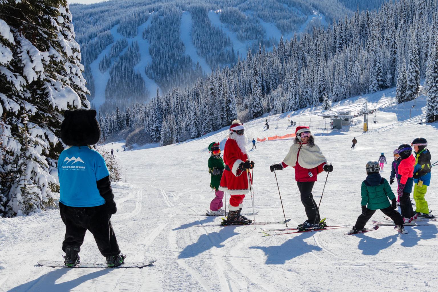 Santa and Mrs. Claus skiing with kids in Sun Peaks