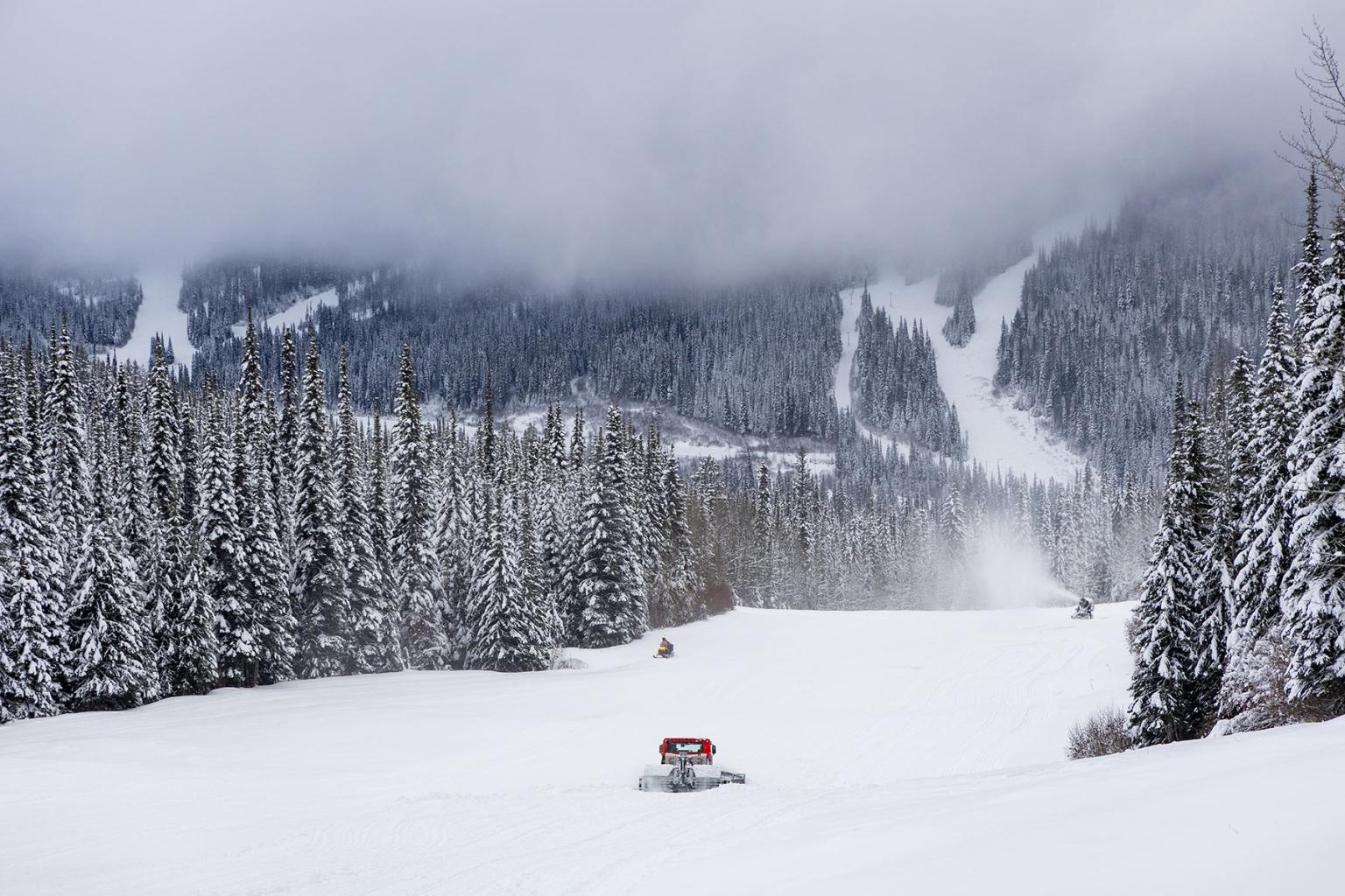 View of a mountain with a Cat and ski runs covered in powder