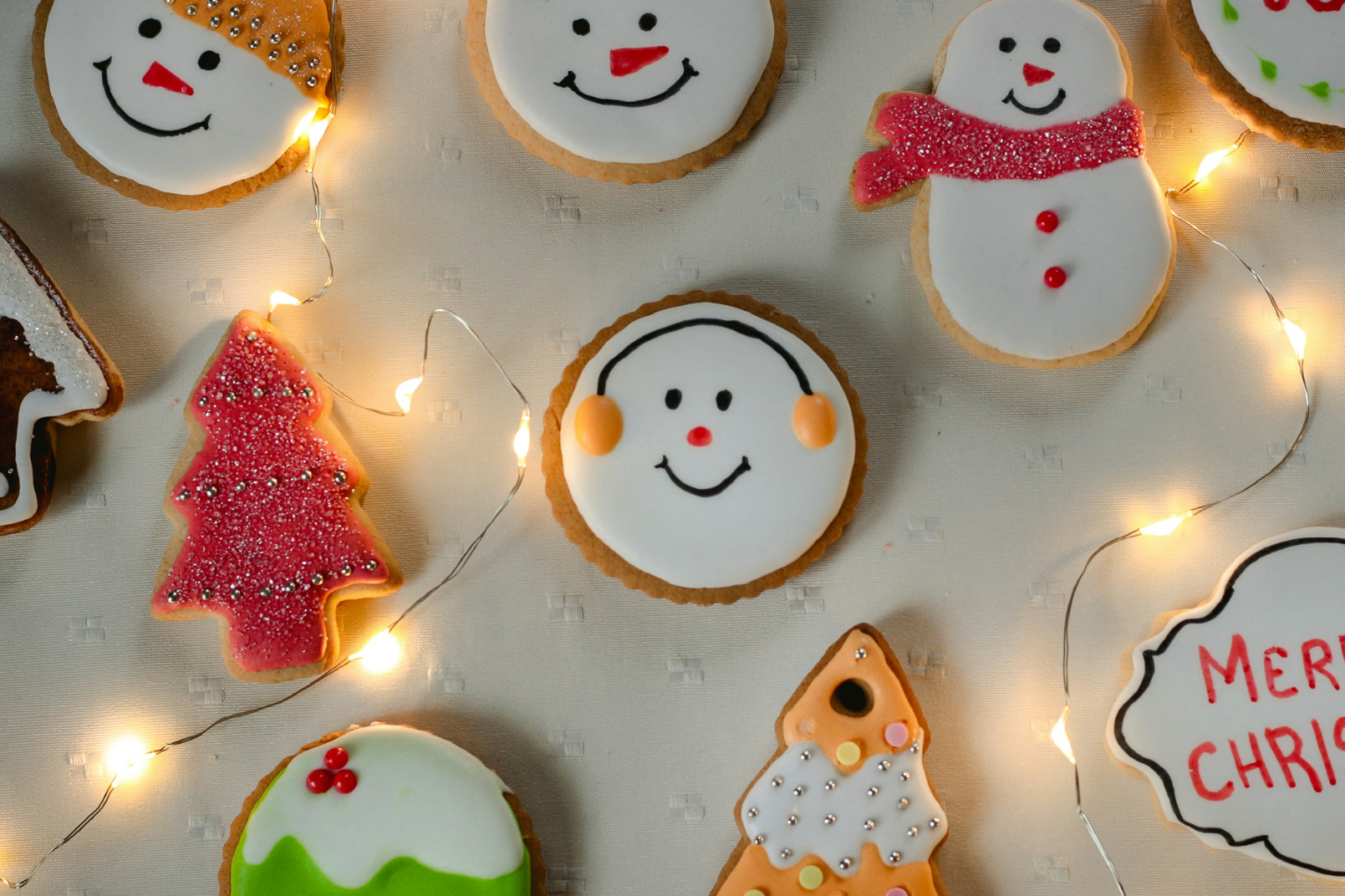 Photo of Christmas cookies on a table with lights around them