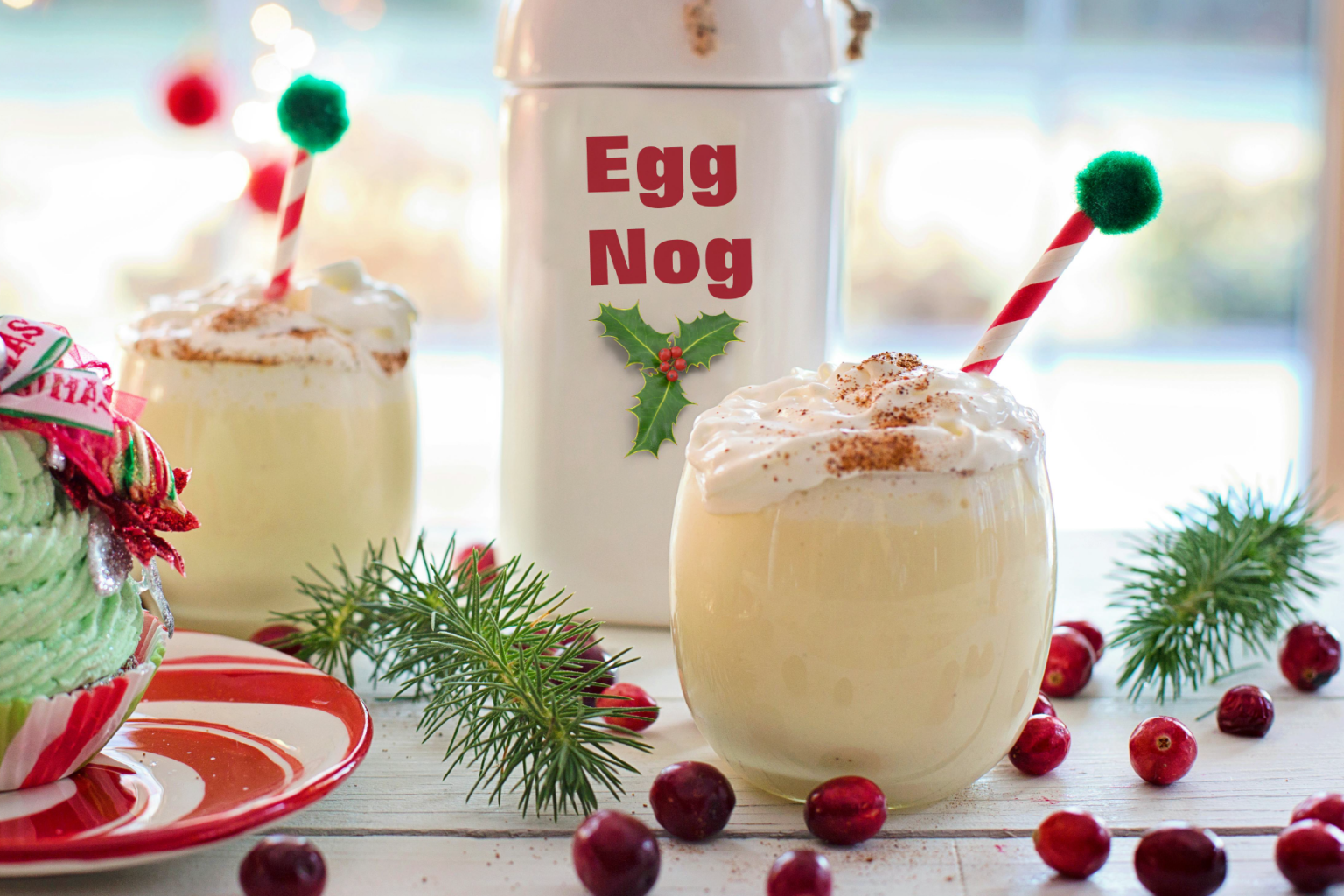 Egg Nog cups with Christmas decorations around them