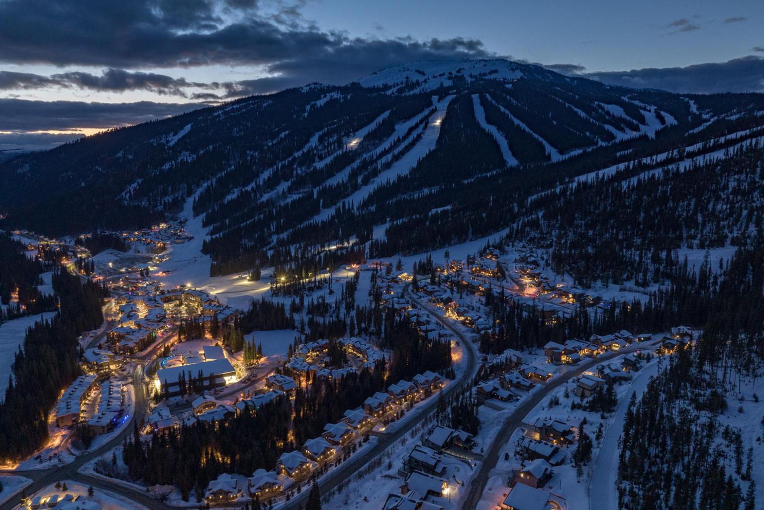 Sun Peaks village from above at dusk in winter.
