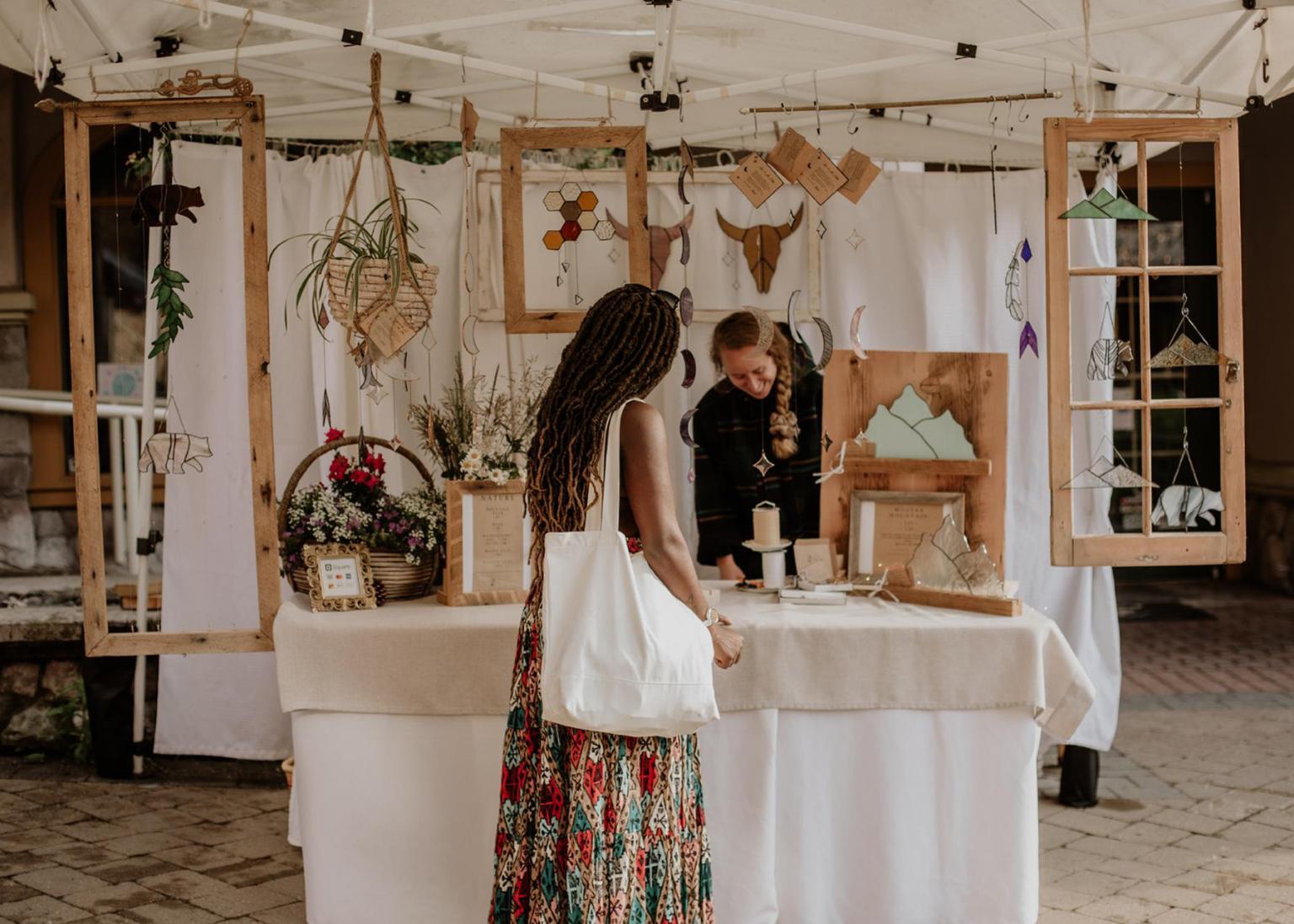 Chioma Harder browsing glassware at Sunday Market Day in Sun Peaks.