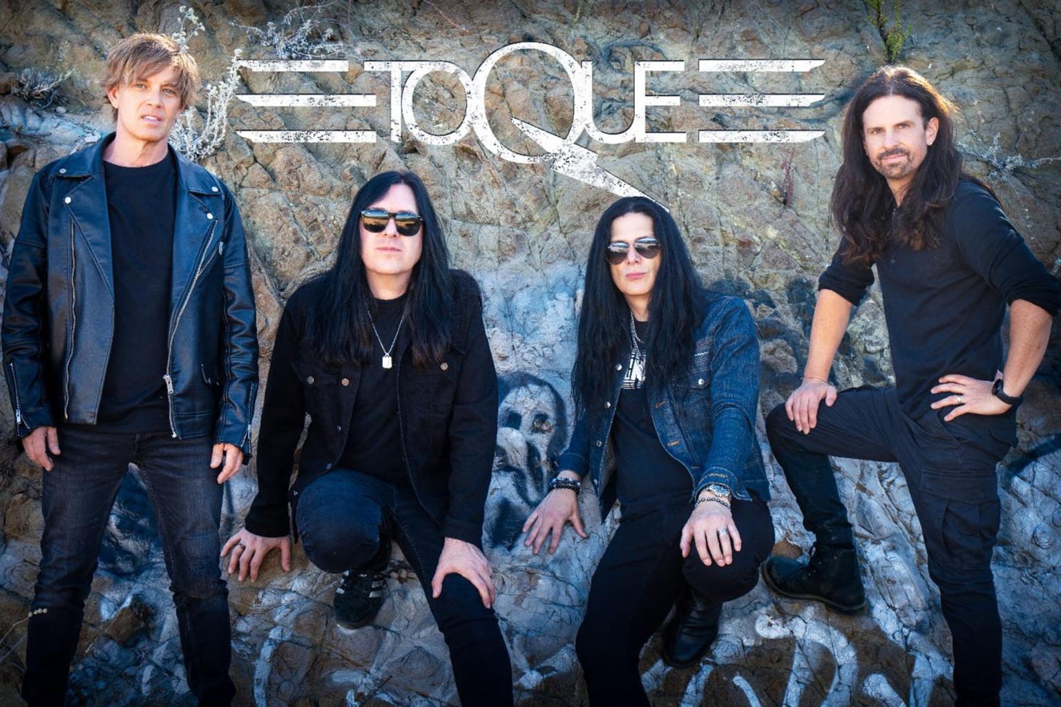 Canadian rock band Toque posing against a graffiti-covered wall.