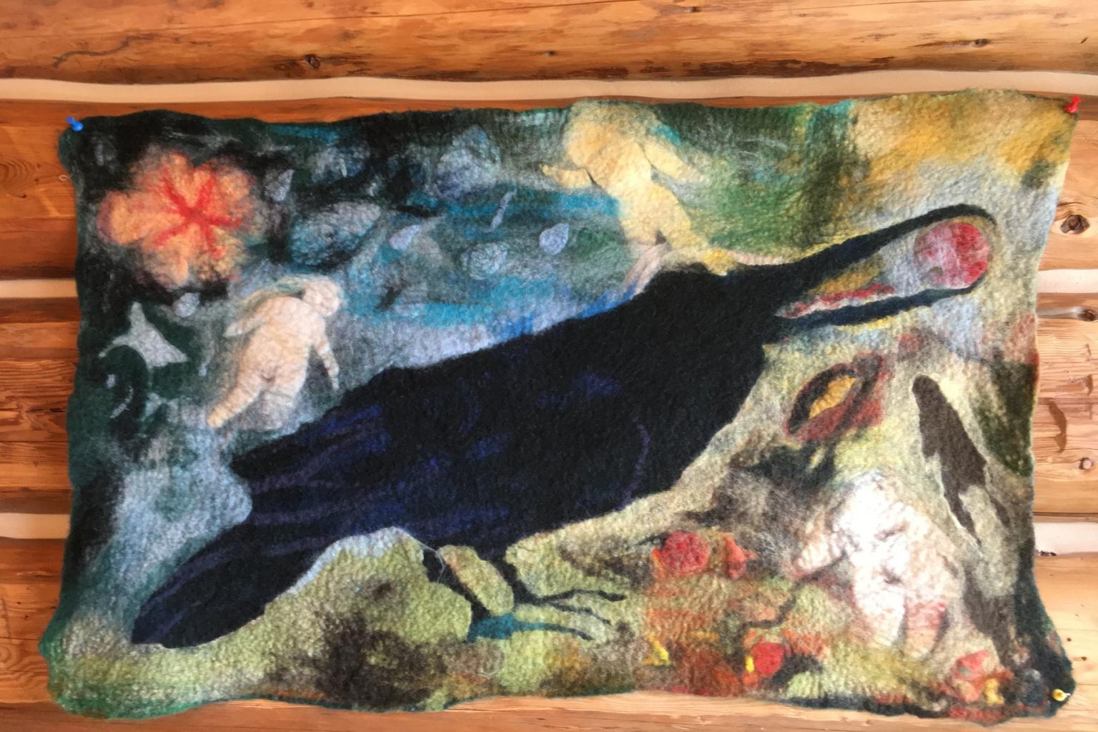 Colorful felted artwork of a black bird with abstract background.