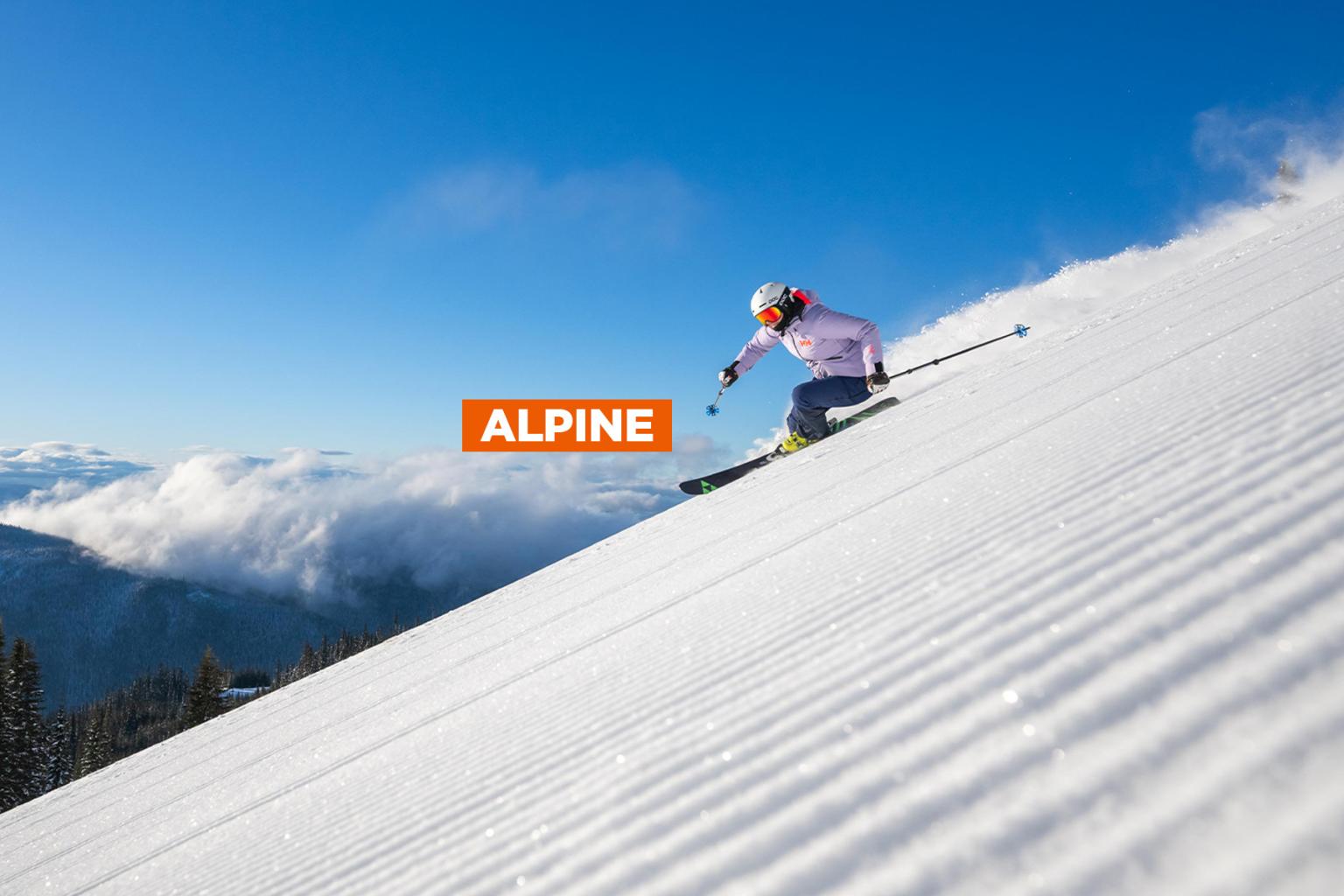 Skier descending a snowy slope under a clear blue sky, with the word “Alpine” overlaid in bold text.