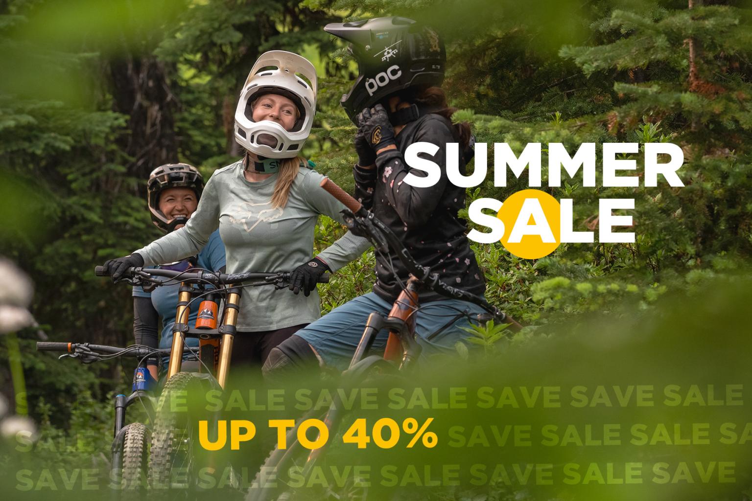 Bikers in forest with summer sale text overlay.