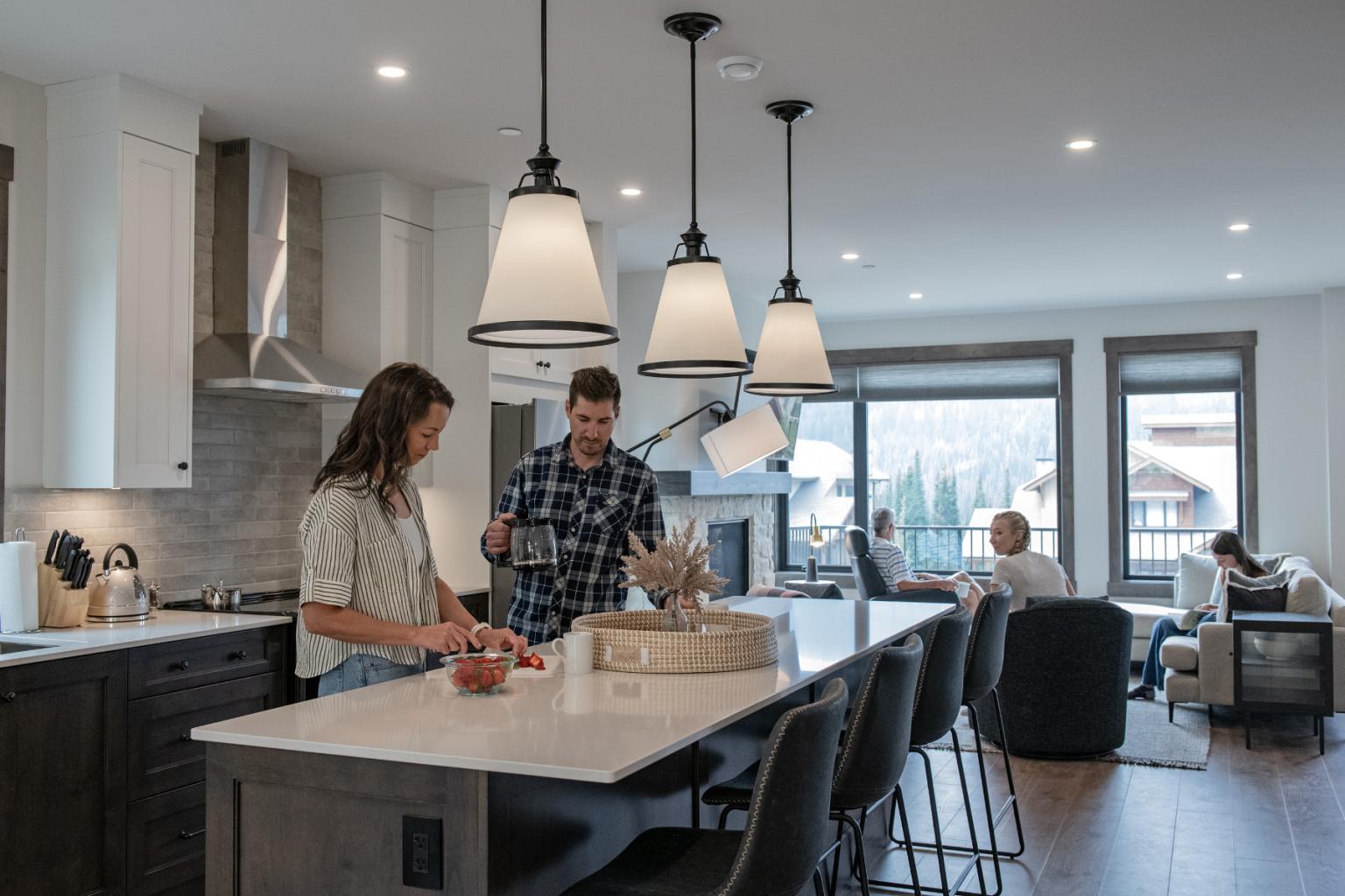 Couple preparing food in a modern kitchen, with a cozy living room background.