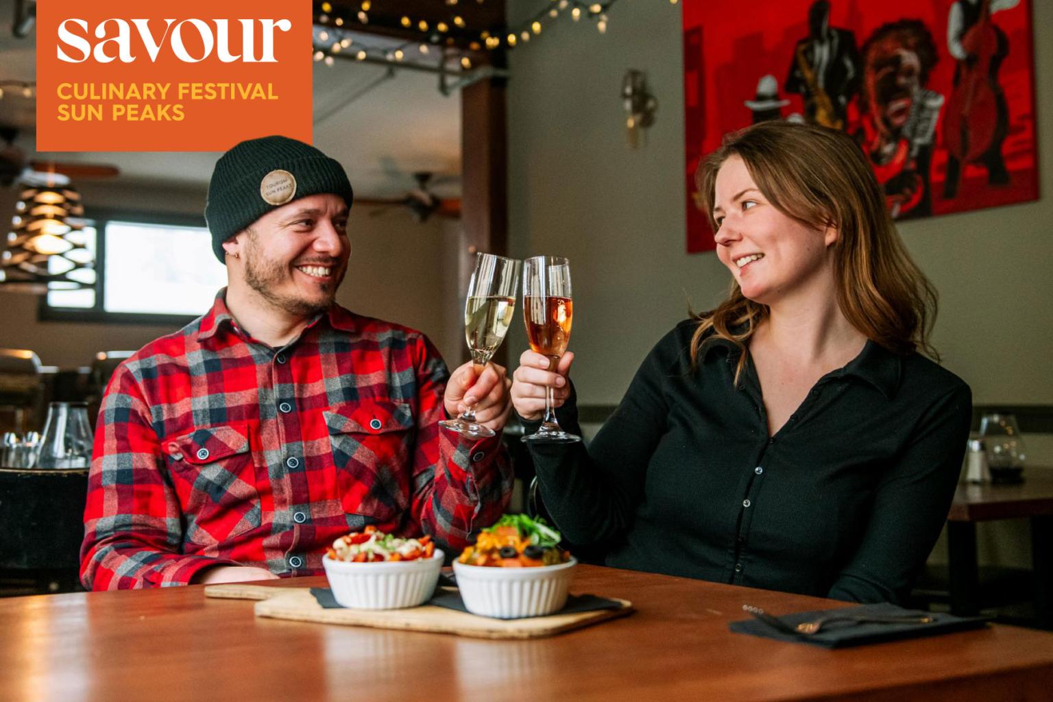 Couple toasting with champagne in a cozy restaurant.