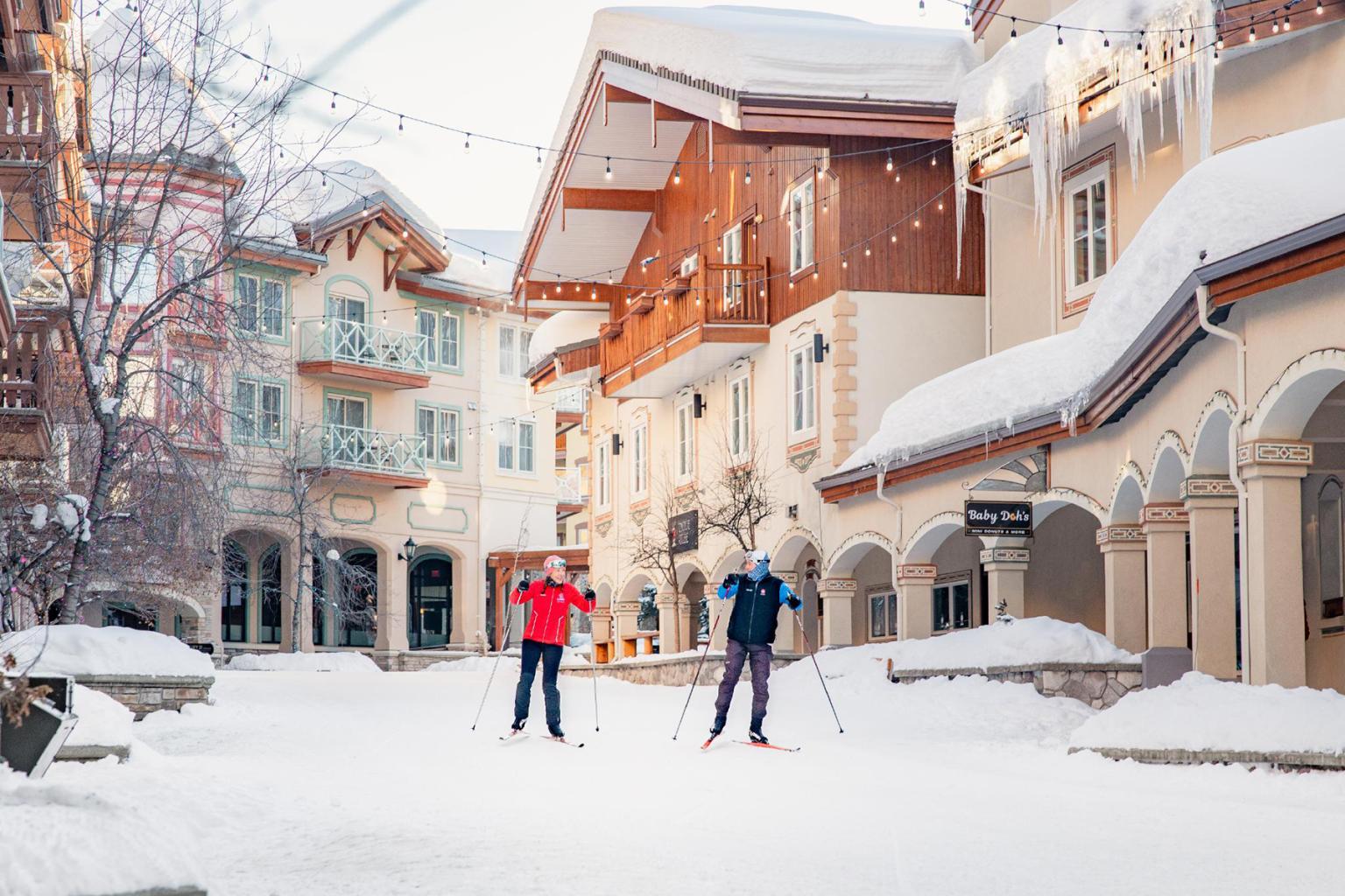 Nordic skiers skiing through the sun peaks village